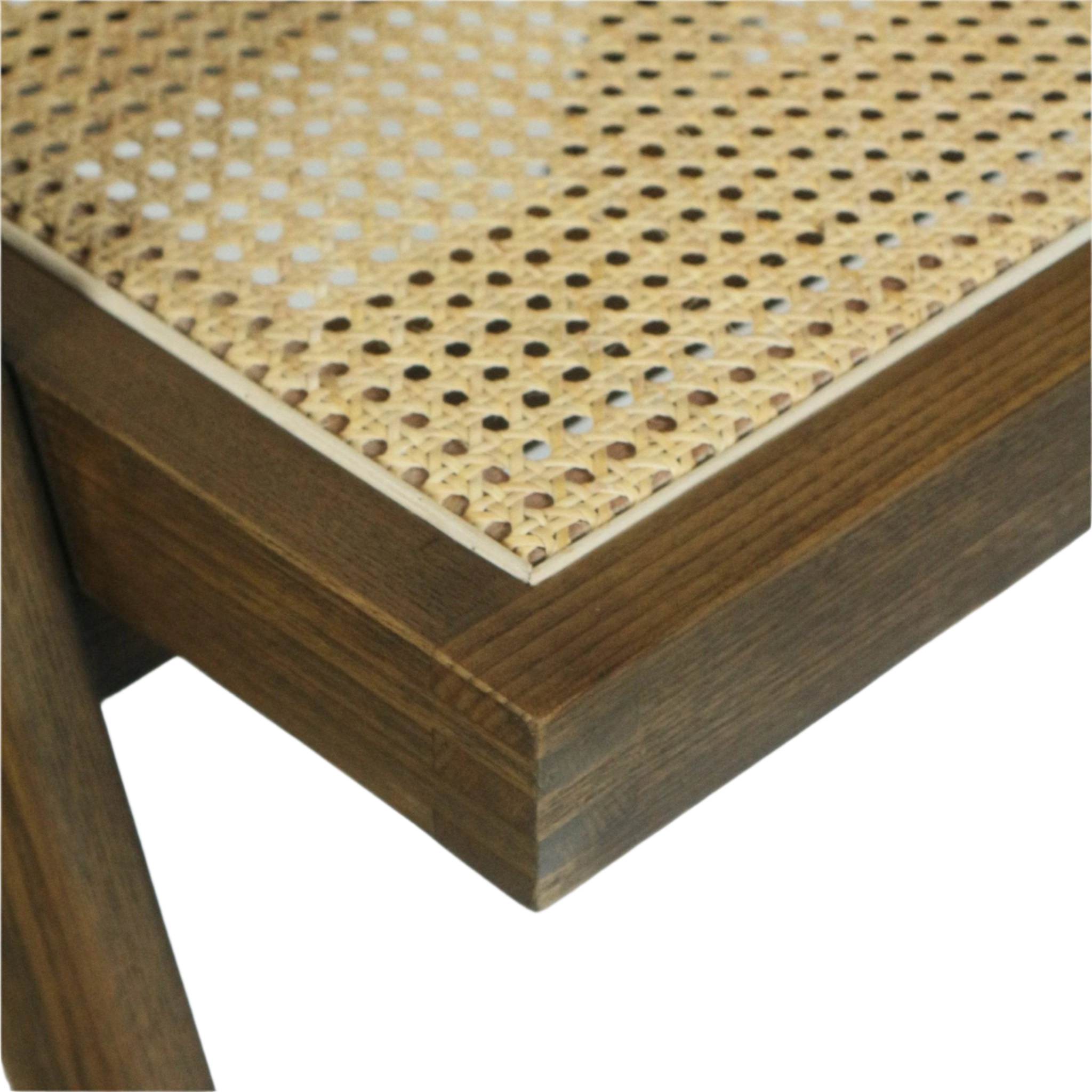 Close-up of a woven rattan cane seat (Vienna weave) inset into a warm teak solid wood frame, showing the perforated cane pattern, corner joint and natural wood grain.