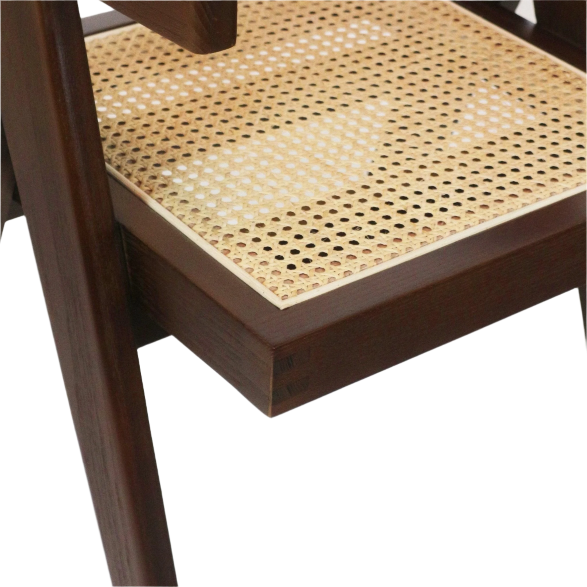 Close-up of a dining chair seat with natural cane weave set into a walnut-stained solid wood frame, showing the woven rattan pattern and exposed corner joinery.