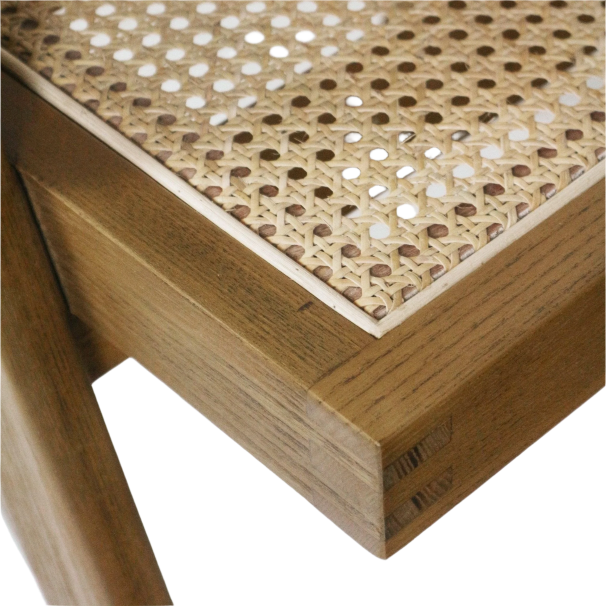 Close-up of a mid-century modern dining chair corner showing a natural teak solid-wood frame with visible joinery and a light Vienna cane weave seat in warm blonde tones.