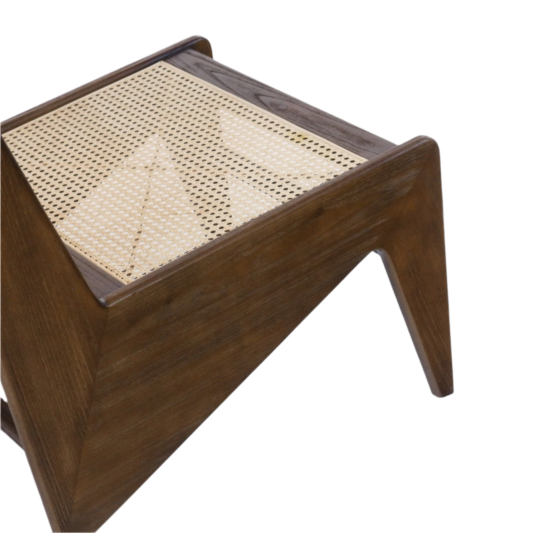 Close-up of a kangaroo-style accent chair showing a warm teak solid wood frame, woven natural cane seat panel and angled low-profile leg in walnut-brown finish.