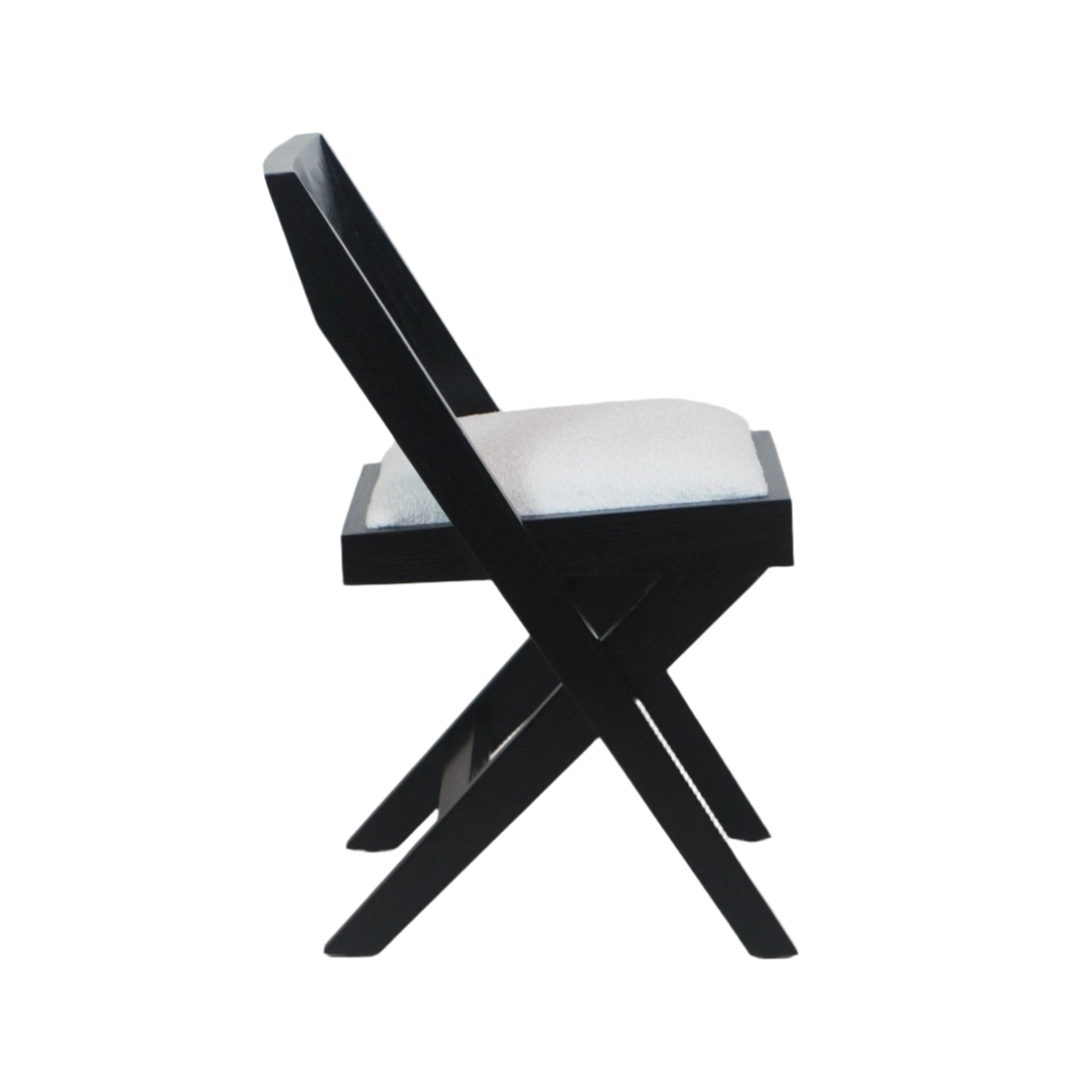 Side profile of a modern side chair with a black wooden X-frame and a white boucle upholstered cushion, low angled backrest and crossed legs on a white background.