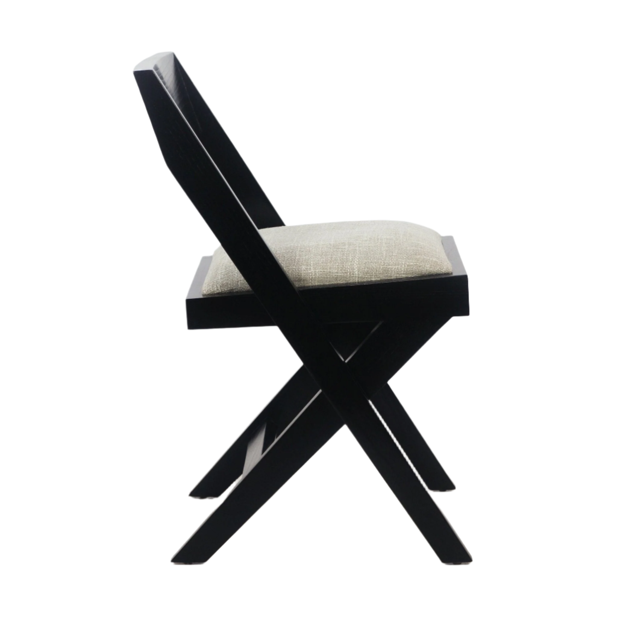 Side view of a side chair with a black wood X-frame and angled back, topped with a beige upholstered cushion seat in a modern mid-century design.