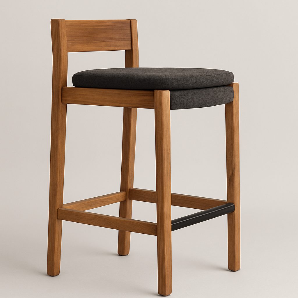 Armless teak bar stool with a natural wood frame, low rectangular back, dark gray upholstered round seat cushion and a metal-wrapped front footrest in a contemporary coastal style.