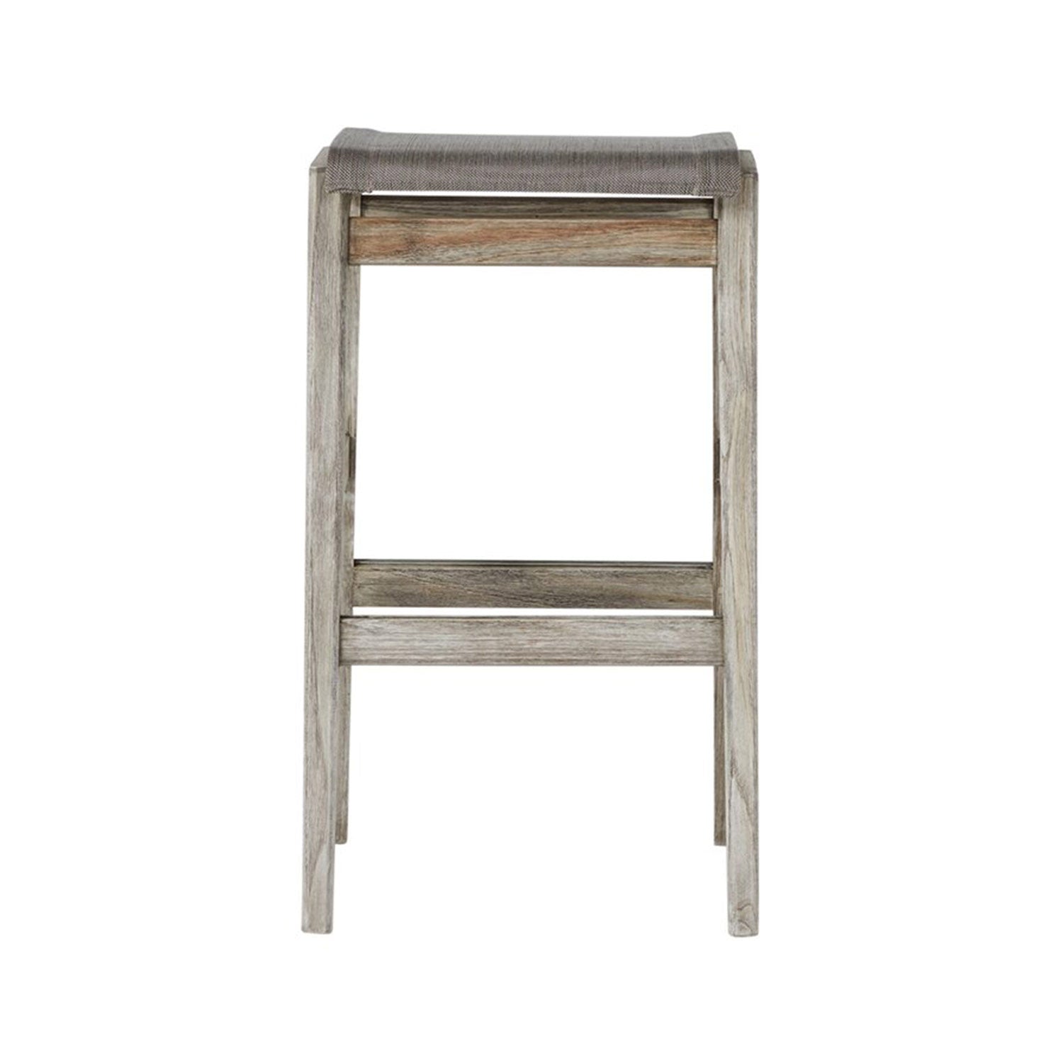 Front view of a backless teak outdoor bar stool in a natural weathered finish with a taupe canvas sling seat, square tapered legs and a built-in footrest, showing a coastal-contemporary minimalist design.