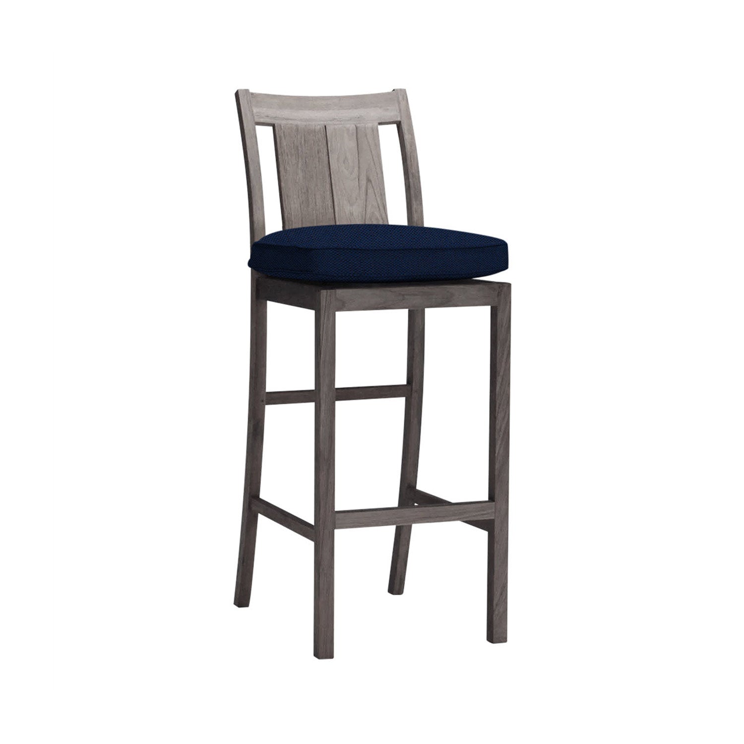 Armless teak outdoor bar stool with weathered teak wood finish, navy cushion, slatted back and built-in footrest, coastal-style solid wood counter stool.