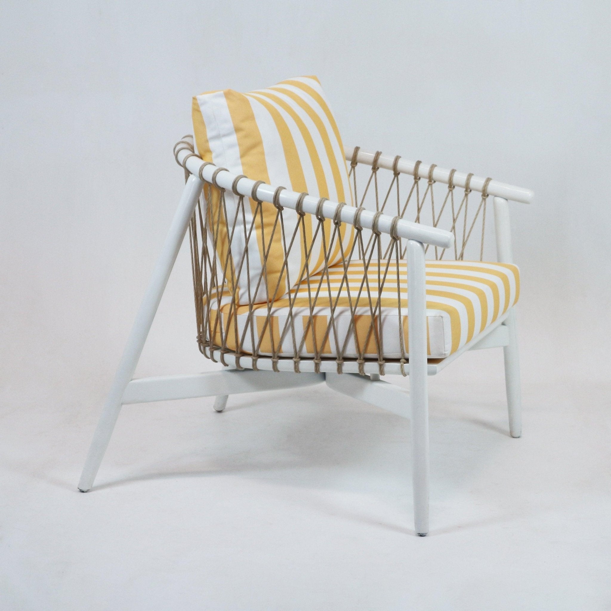 Modern lounge chair with a white wooden frame, woven natural rope sides, and yellow-and-white striped fabric seat cushion and back pillow on a plain background.
