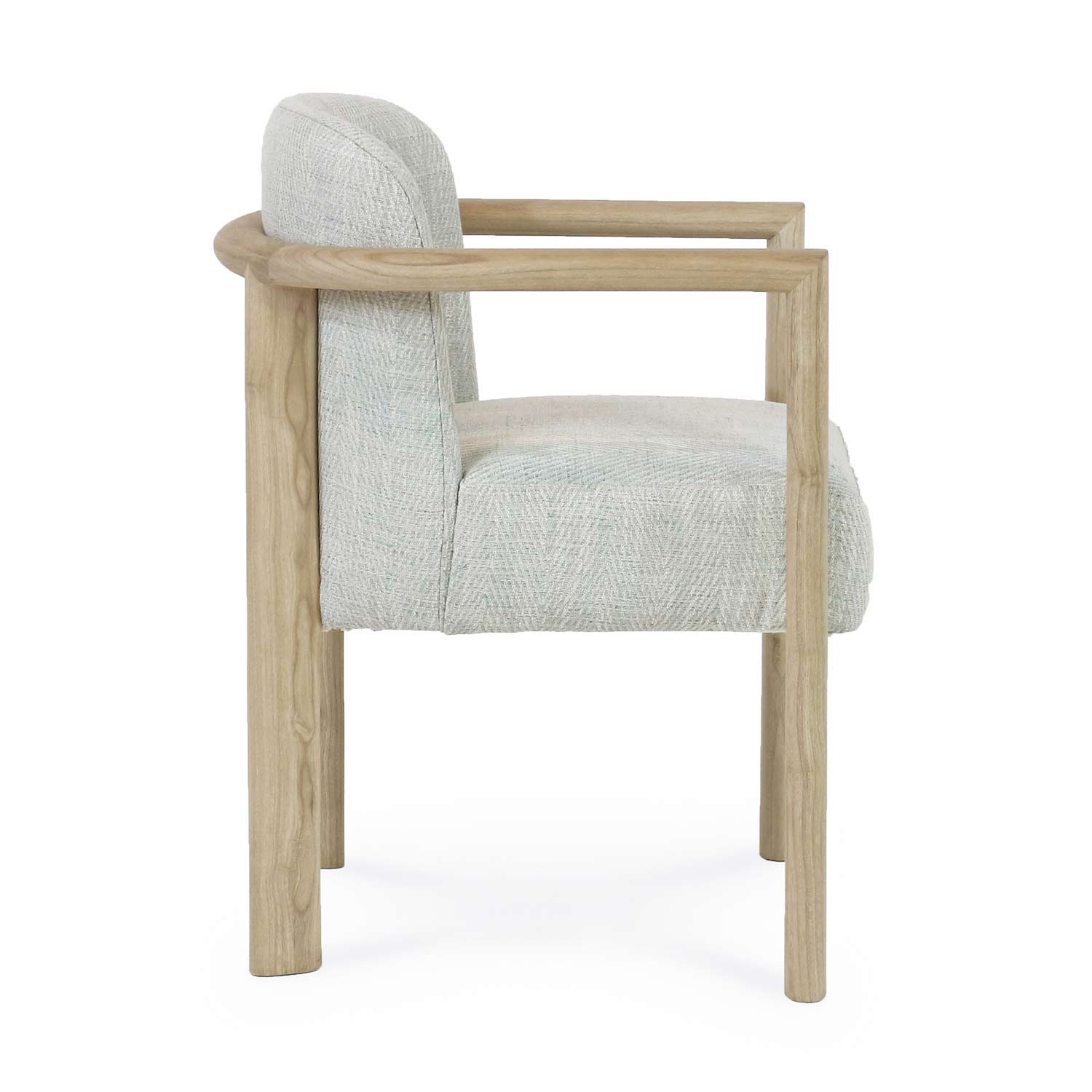 Side view of a modern dining chair with a light oak wood frame and rounded armrests, upholstered in a light neutral textured fabric with a cushioned seat and full back.