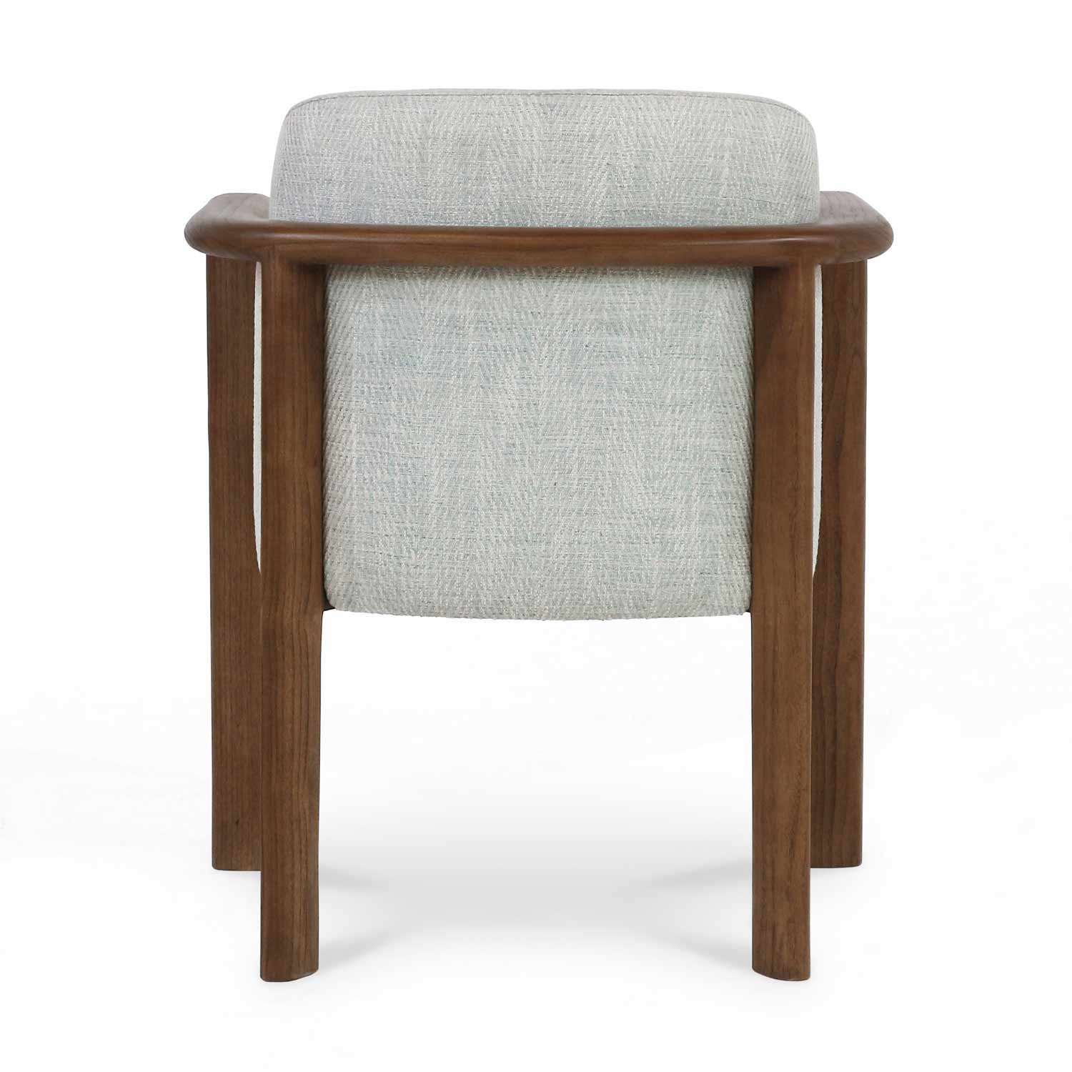 Rear view of a modern dining chair with light herringbone-patterned fabric upholstery and a rounded oak wood frame and legs.