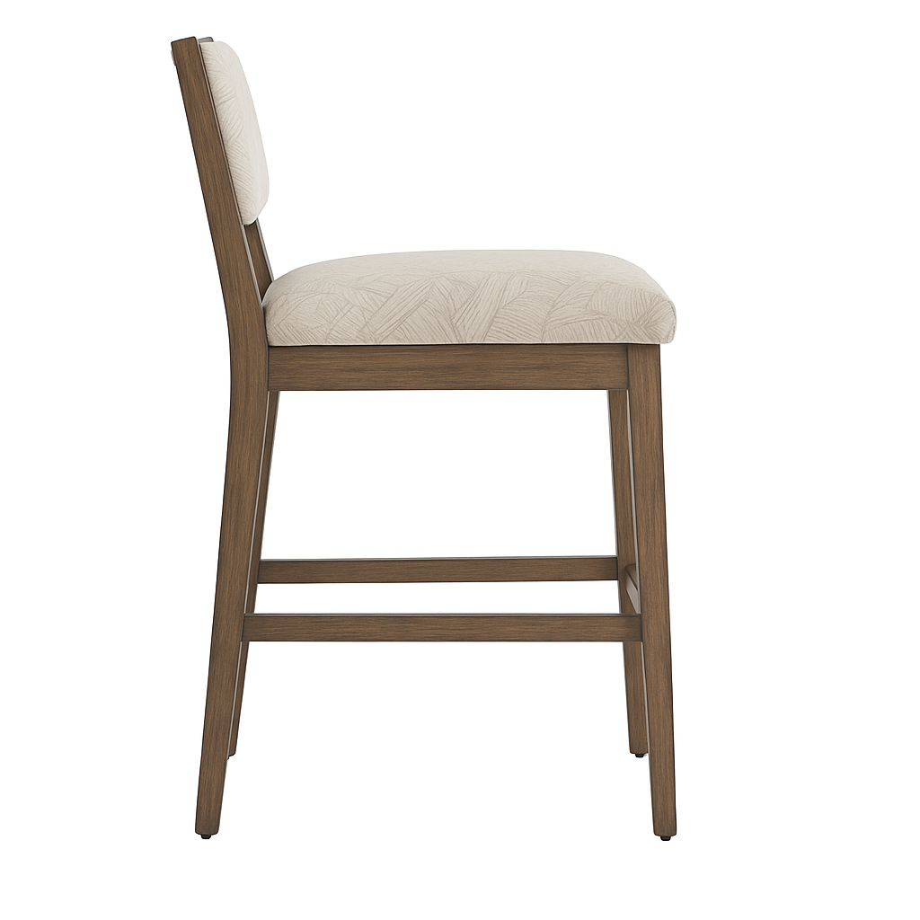 Side view of an armless teak bar stool with warm teak wood frame and beige patterned upholstered seat and low cushioned back, featuring straight legs and a double footrest in a coastal contemporary style.