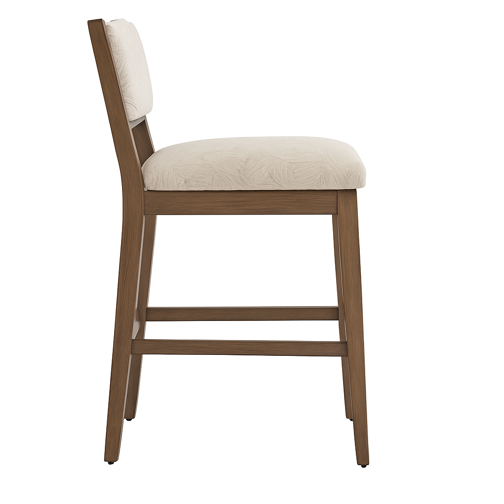 Side profile of a teak wood armless counter stool with a beige upholstered seat and low padded back, tapered legs and integrated footrest on a white background.