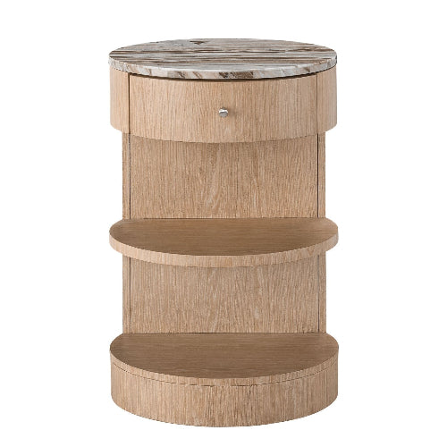 Round marble-top nightstand in natural blonde wood with a curved solid-wood base, one front drawer with a small metal knob, and two open semicircular shelves.
