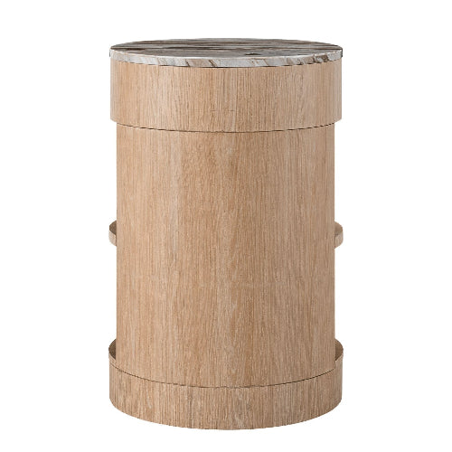 Cylindrical solid wood nightstand in a light blonde finish topped with a round white-and-gray marble top, minimalist modern bedside table with a smooth curved base.