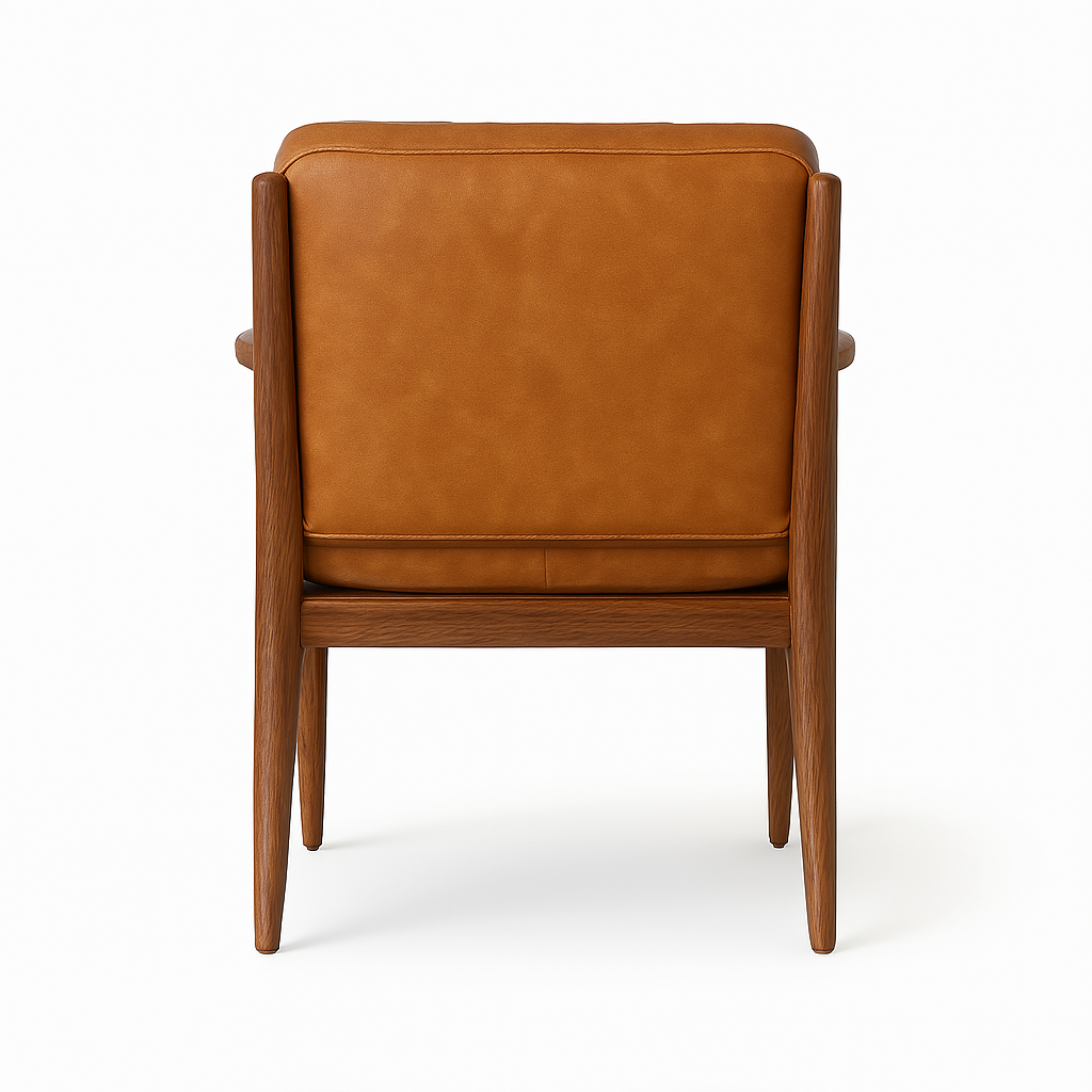 Rear view of a dining chair upholstered in aged nubuck tan leather with a walnut wood frame, tapered legs and slim arm supports, showing the padded back and wooden base.