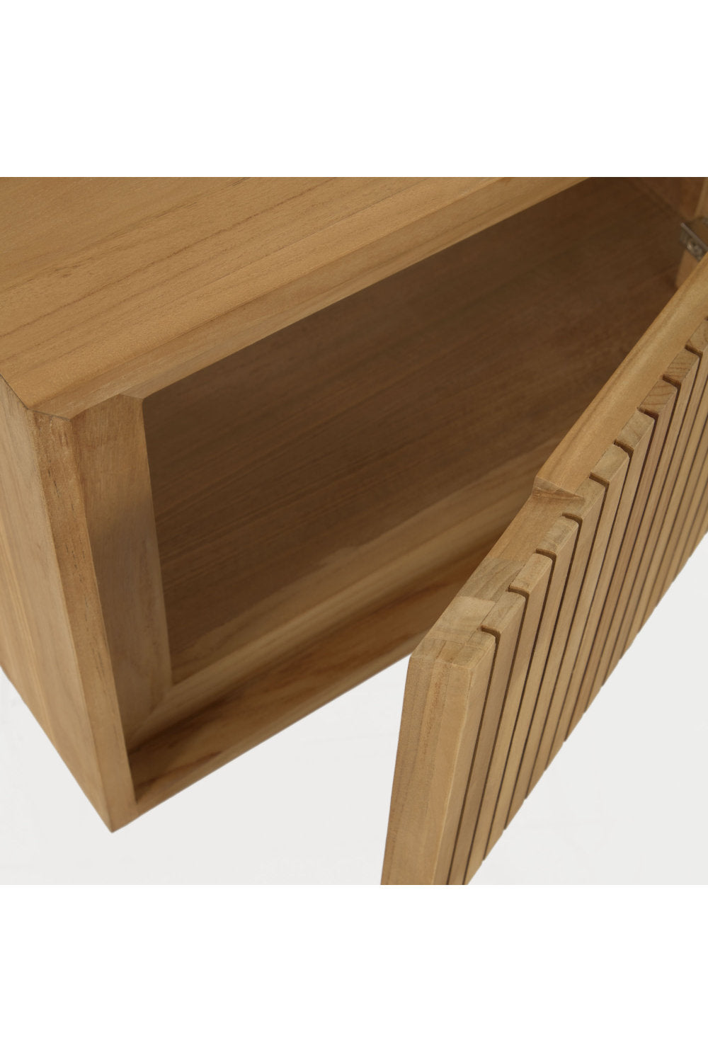 Close-up of a modern solid wood bathroom vanity showing the open cabinet interior and slatted front door in a warm stone-toned finish