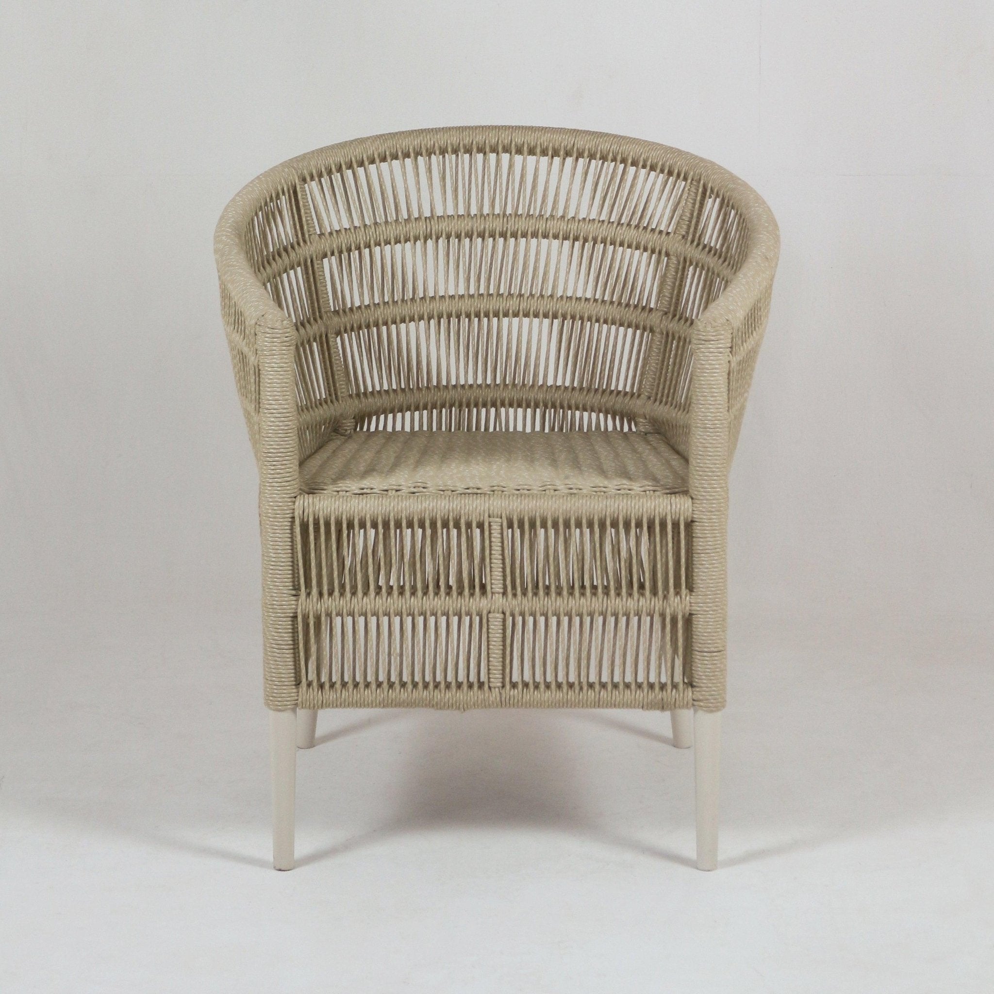 Front view of a beige woven rope outdoor patio armchair with a rounded back and integrated woven seat, supported by slim white metal legs in a coastal style.