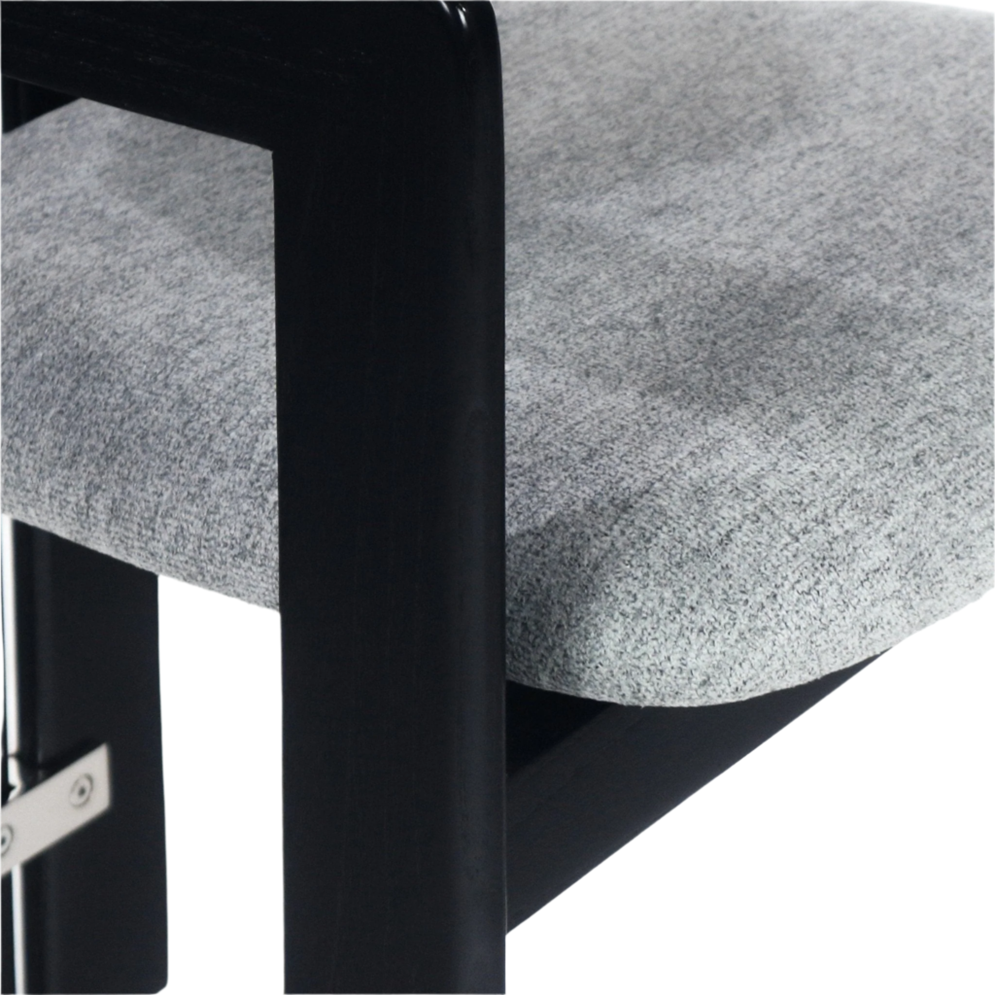 Close-up of a grey boucle upholstered seat and rounded black wood frame leg with visible stainless metal hardware on a modern dining chair.