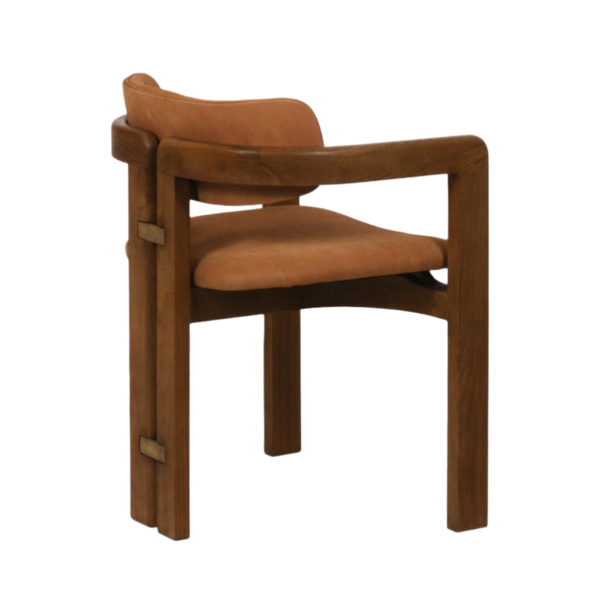 Rear three-quarter view of a mid-century modern dining chair with solid teak frame, curved armrests and warm tan nubuck leather seat and low back, accented by small brass rectangular hardware on the rear legs.