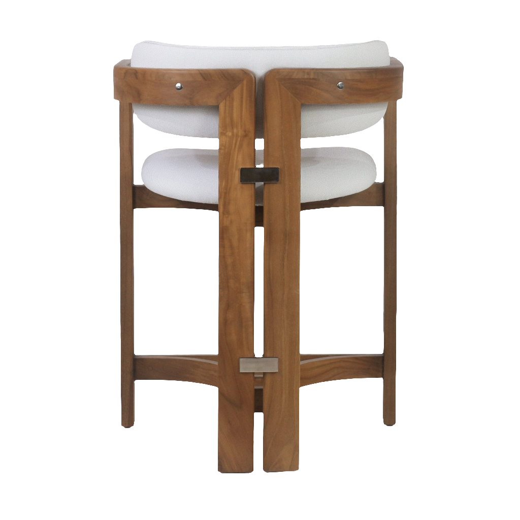 Rear view of an outdoor teak bar stool with white fabric seat and back cushions, solid teak frame, curved backrest and stainless steel footrest brackets.