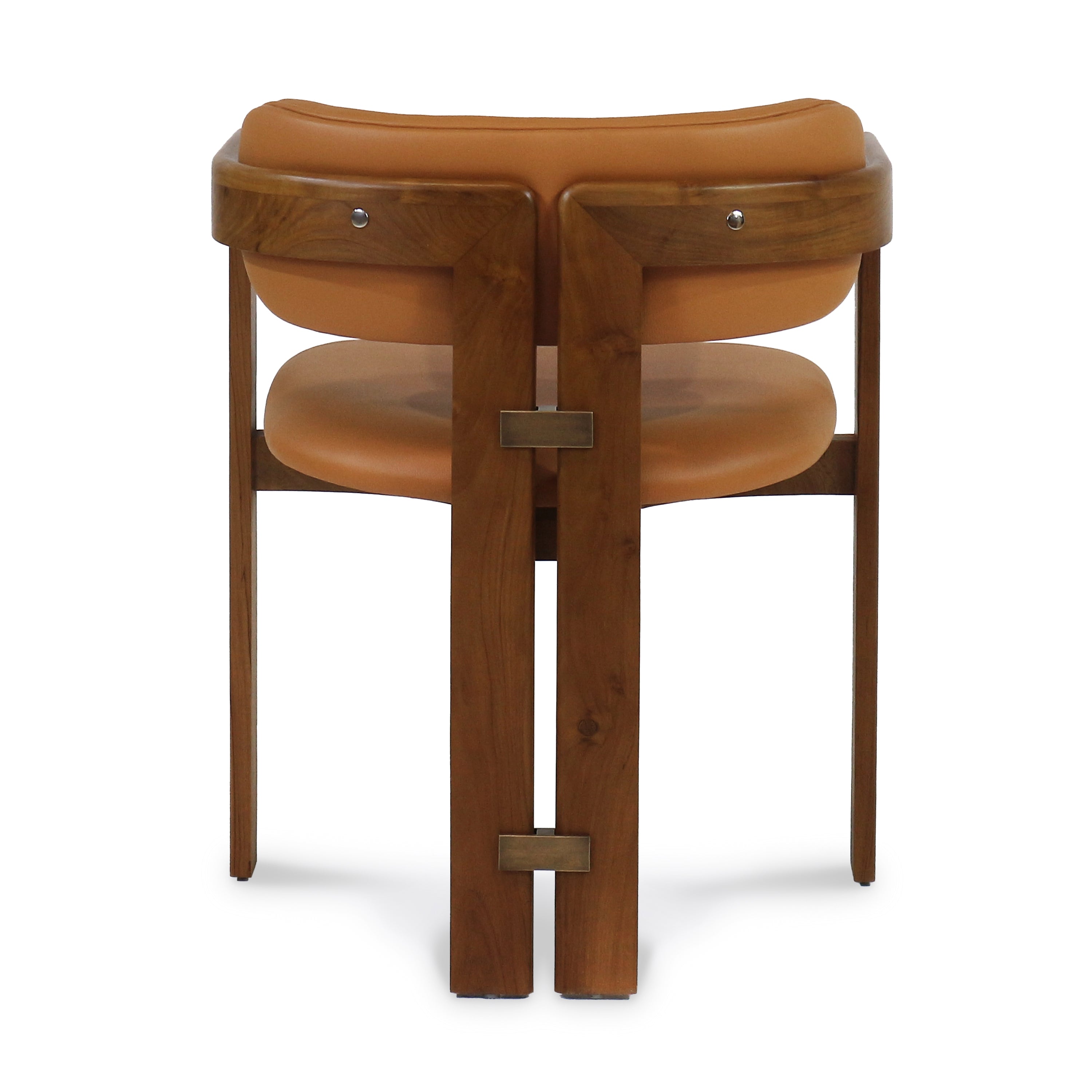 Rear view of a mid-century modern walnut dining chair with tan nubuck leather seat and curved back, brass rectangular hardware accents and tapered wooden legs.