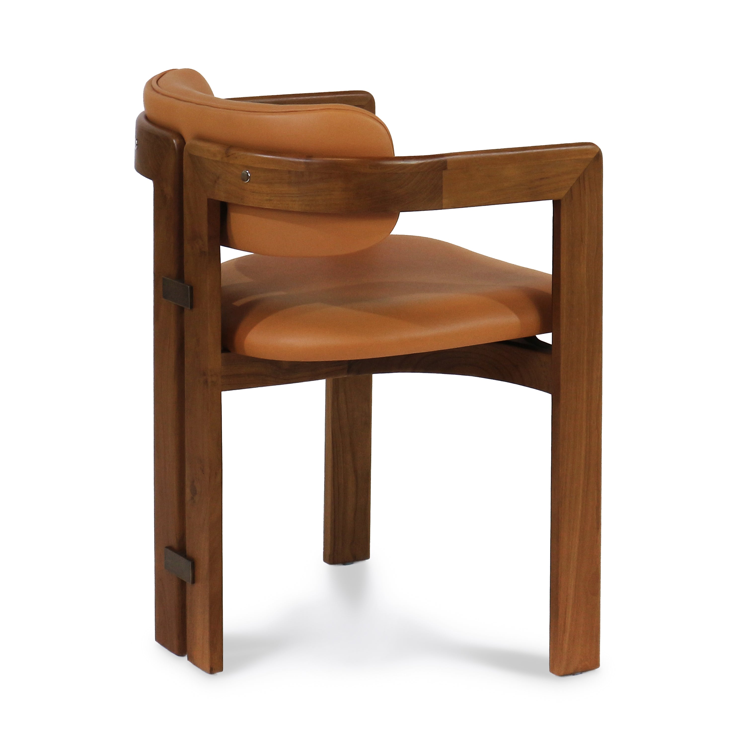 Rear three-quarter view of a mid-century modern dining chair with a walnut frame and tan nubuck leather seat and curved back, integrated wood arms and visible metal accent joinery.