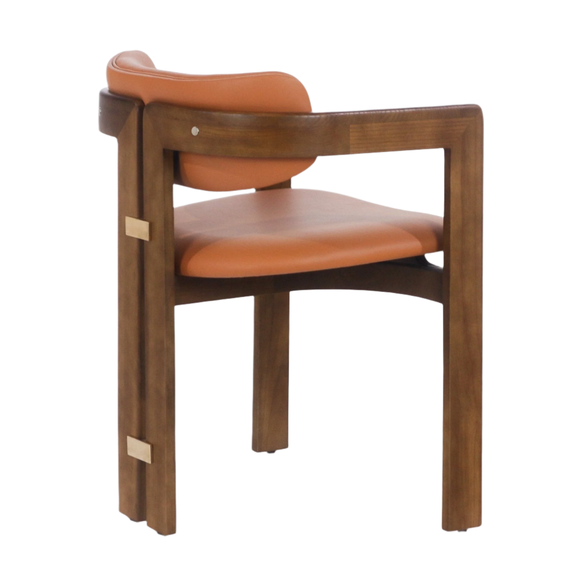 Rear-side view of a mid-century modern dining chair featuring a walnut wood frame, curved tan leather seat and low back, open arm supports and brass rectangular accents on the leg.