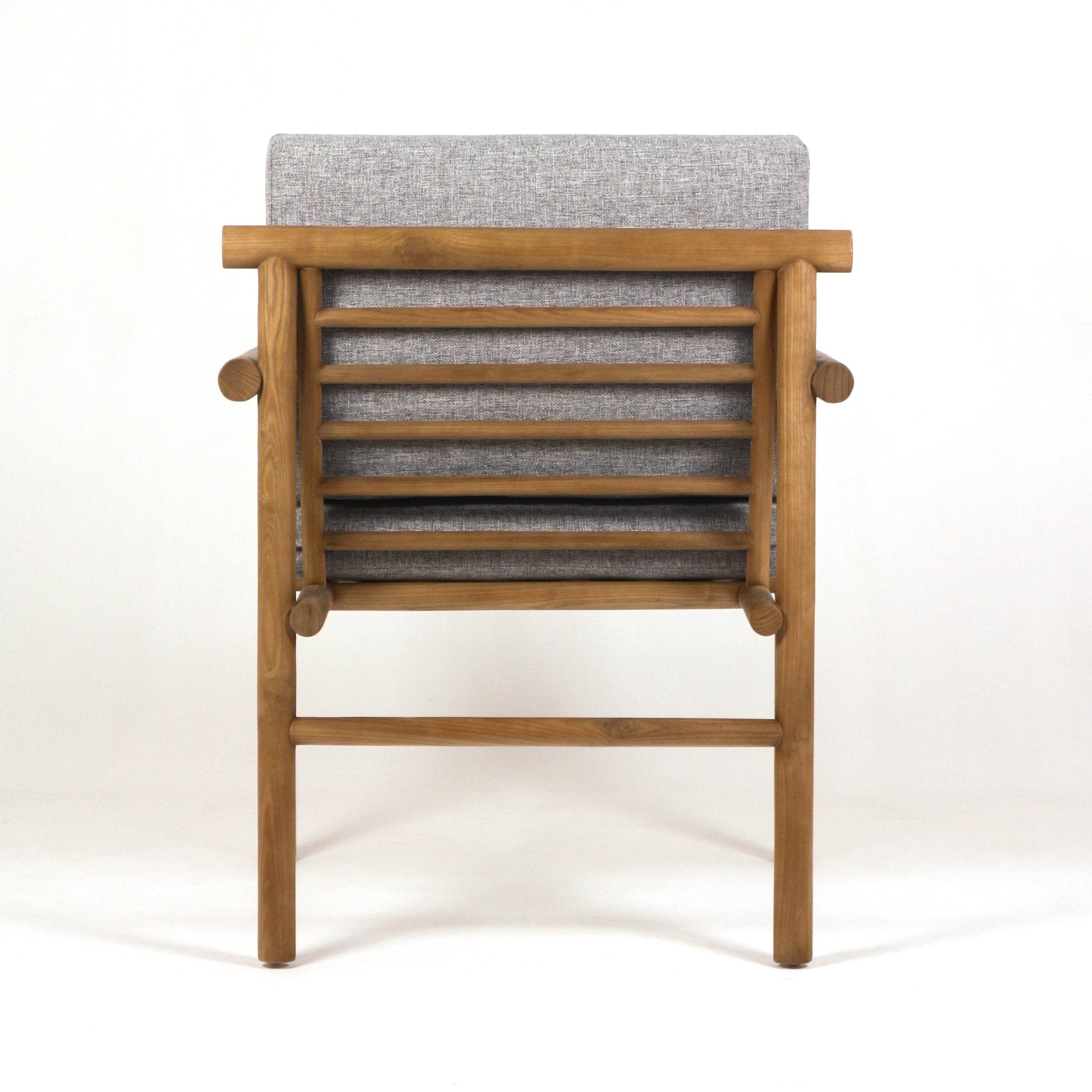 Rear view of a patio chair featuring a natural teak slatted frame with rounded dowel joints and a gray upholstered outdoor fabric cushion visible through the horizontal slats.