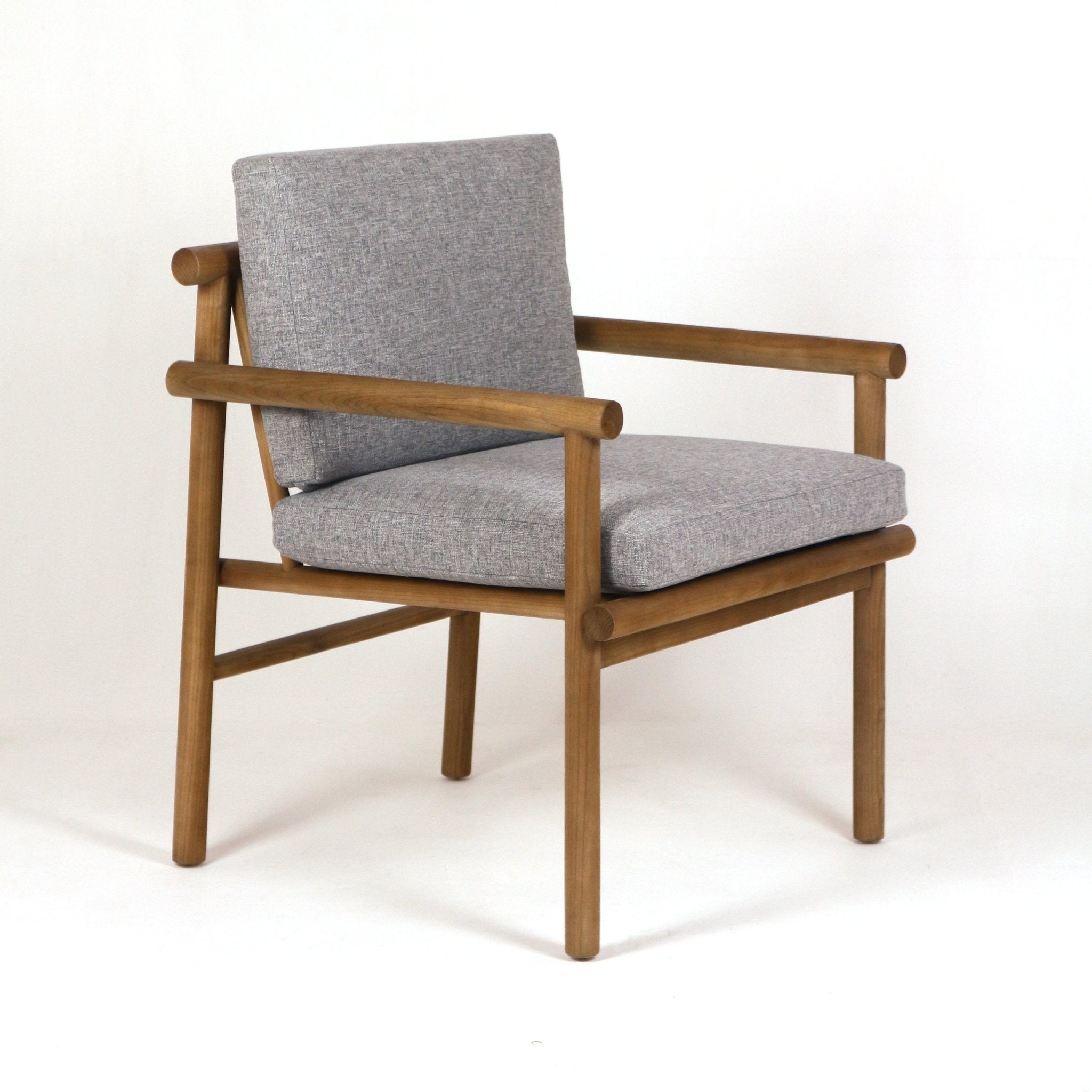 Patio armchair with a natural teak wood frame and rounded tubular arms, upholstered with light gray Sunbrella fabric seat and back cushions, shown on a white background.