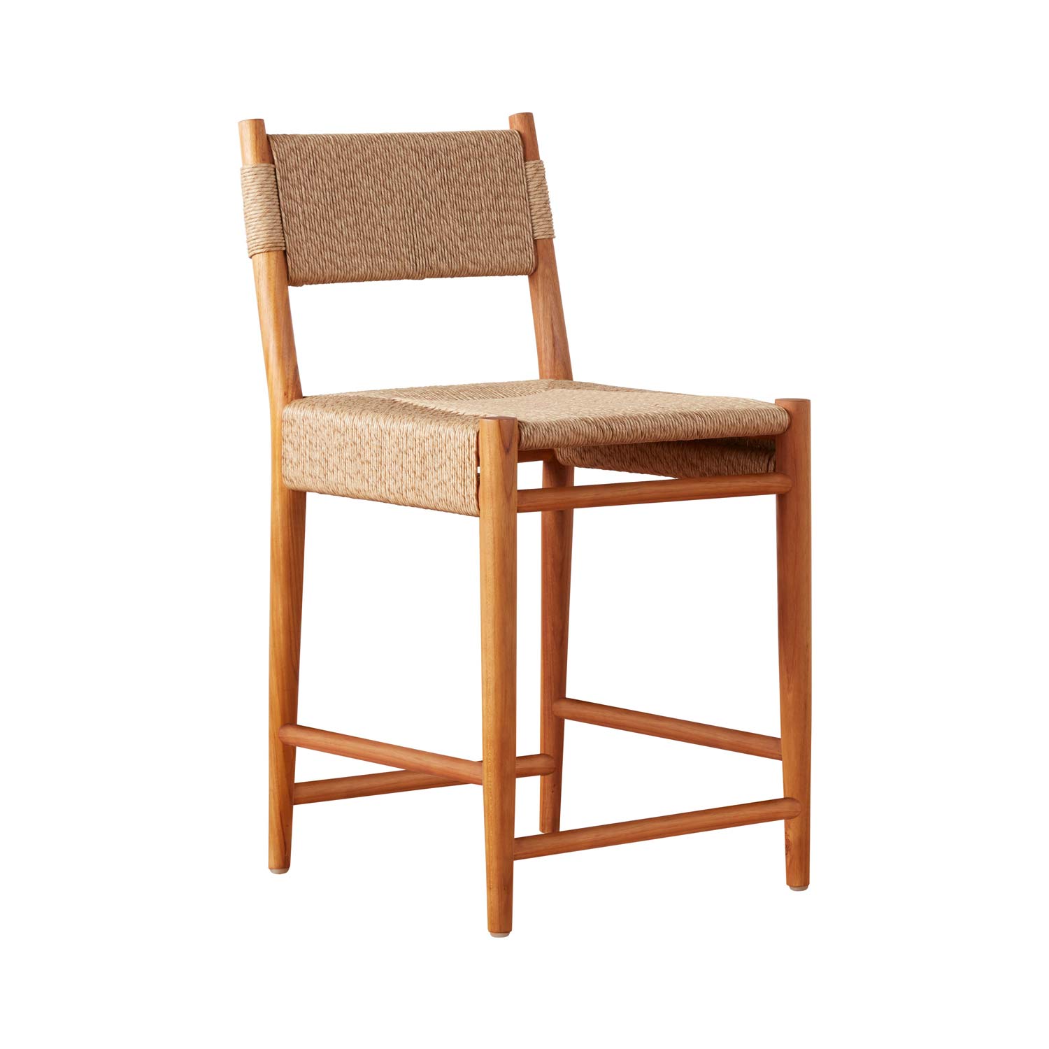 Armless outdoor bar stool with a natural teak frame and woven natural fiber seat and back, tapered legs and integrated footrest in a coastal modern farmhouse style.