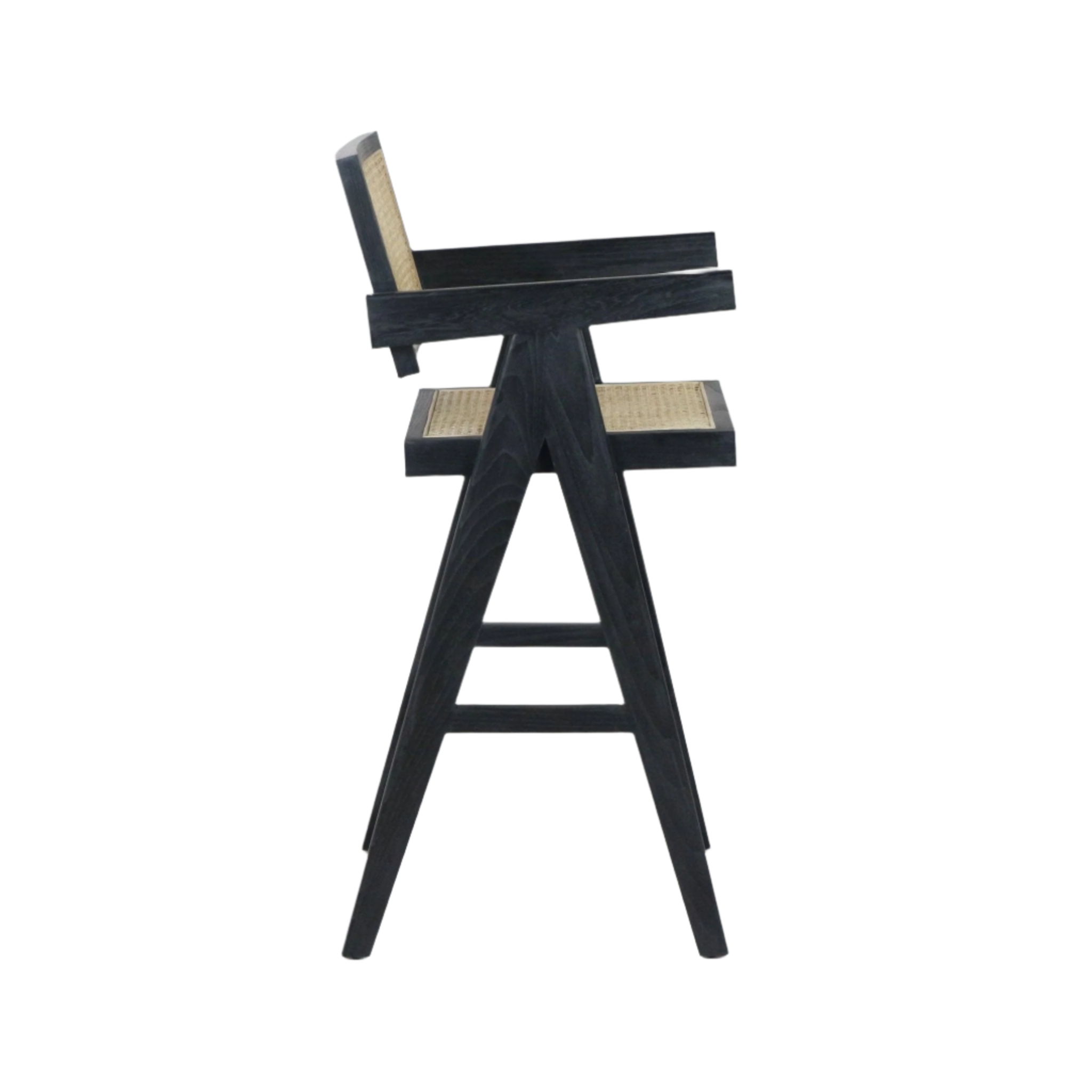 Side view of a black-stained wooden bar stool with woven natural rattan seat and back, A-frame tapered legs, integrated armrests and a footrest in a mid-century modern style.