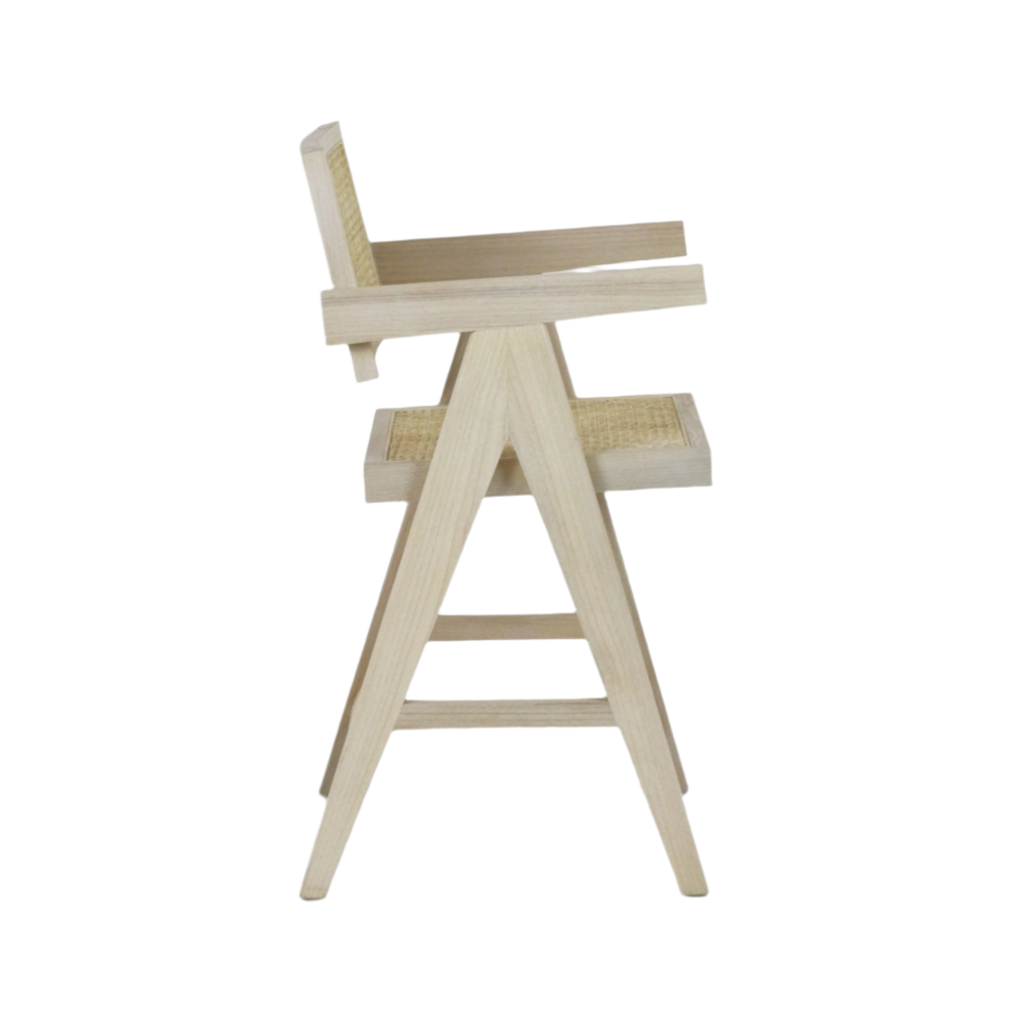 Side view of a natural blonde wood bar stool with woven rattan seat and backrest, A-frame legs, footrest slats and angled armrests in a mid-century modern style.