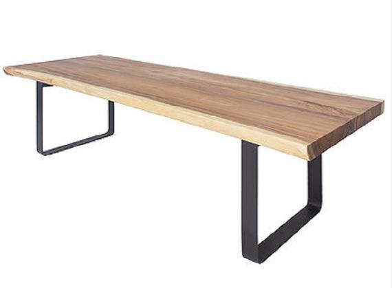Modern rectangular dining table with a thick natural solid-wood live-edge tabletop in warm brown tones and black metal U-shaped legs, photographed on a white background.