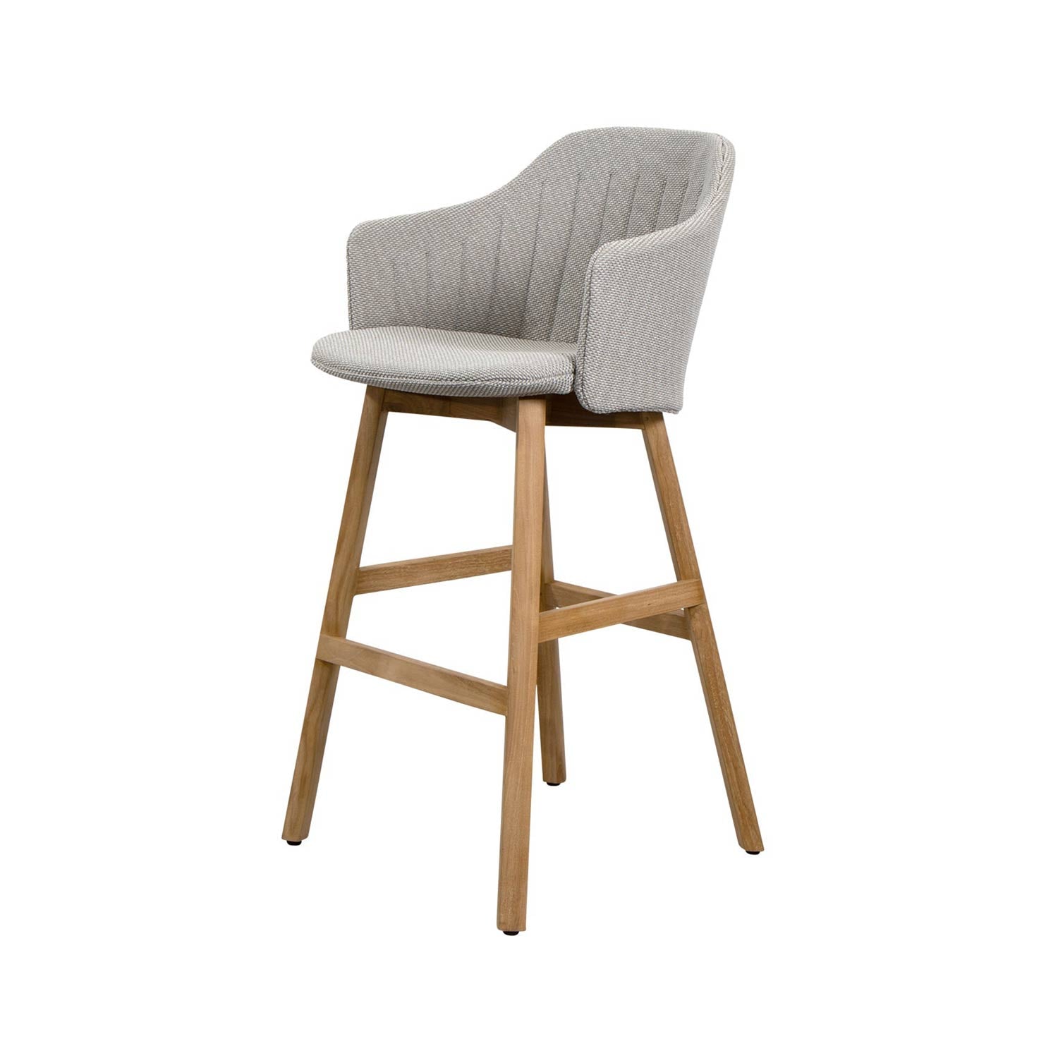 Coastal-style outdoor bar stool with gray fabric upholstery, curved cushioned back and armrests, round seat and natural teak four-leg base with cross stretchers and footrest.
