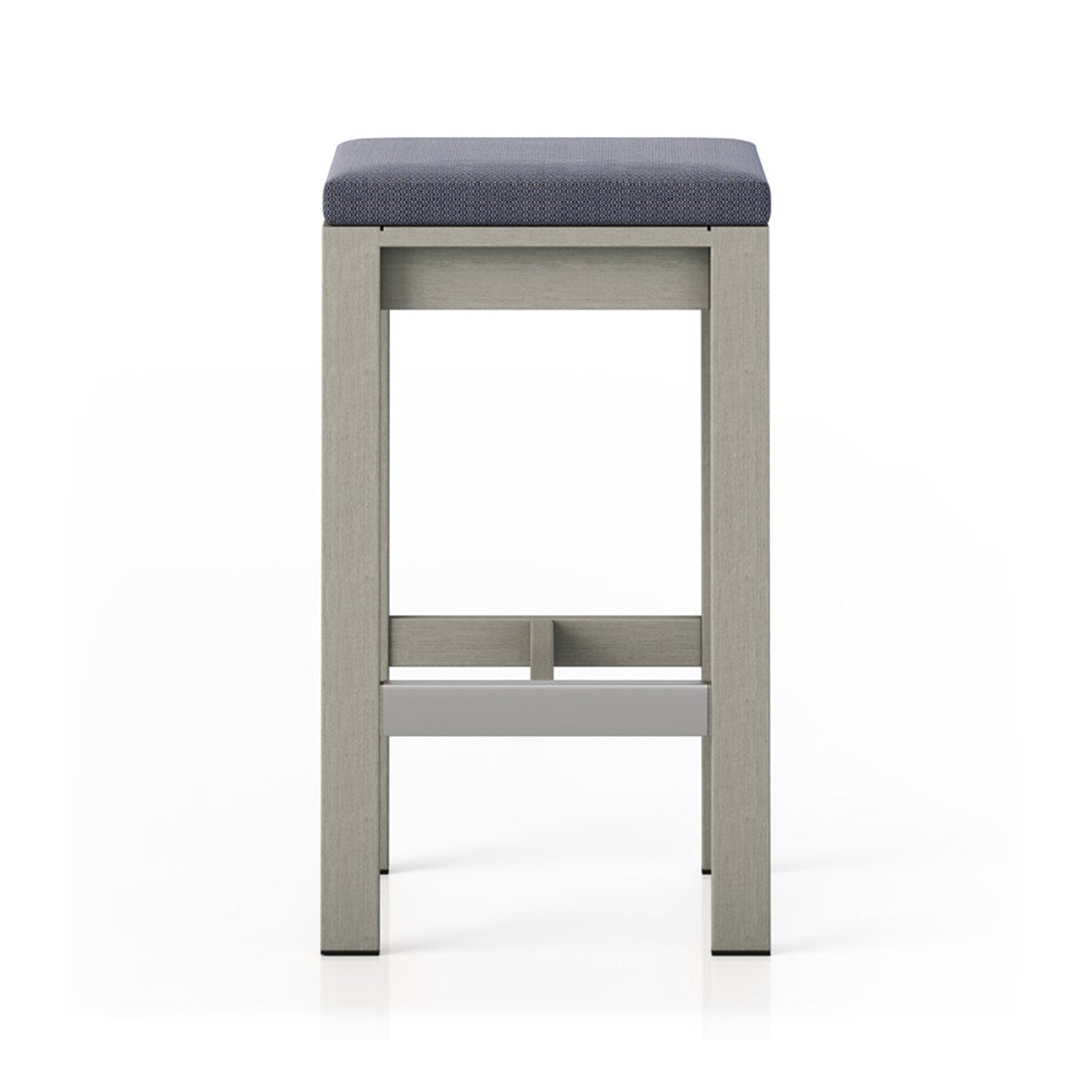 Front view of a backless outdoor bar stool with a light teak solid-wood frame and blue-gray upholstered cushion top, square legs and a low stretcher that doubles as a footrest for coastal or modern patios.