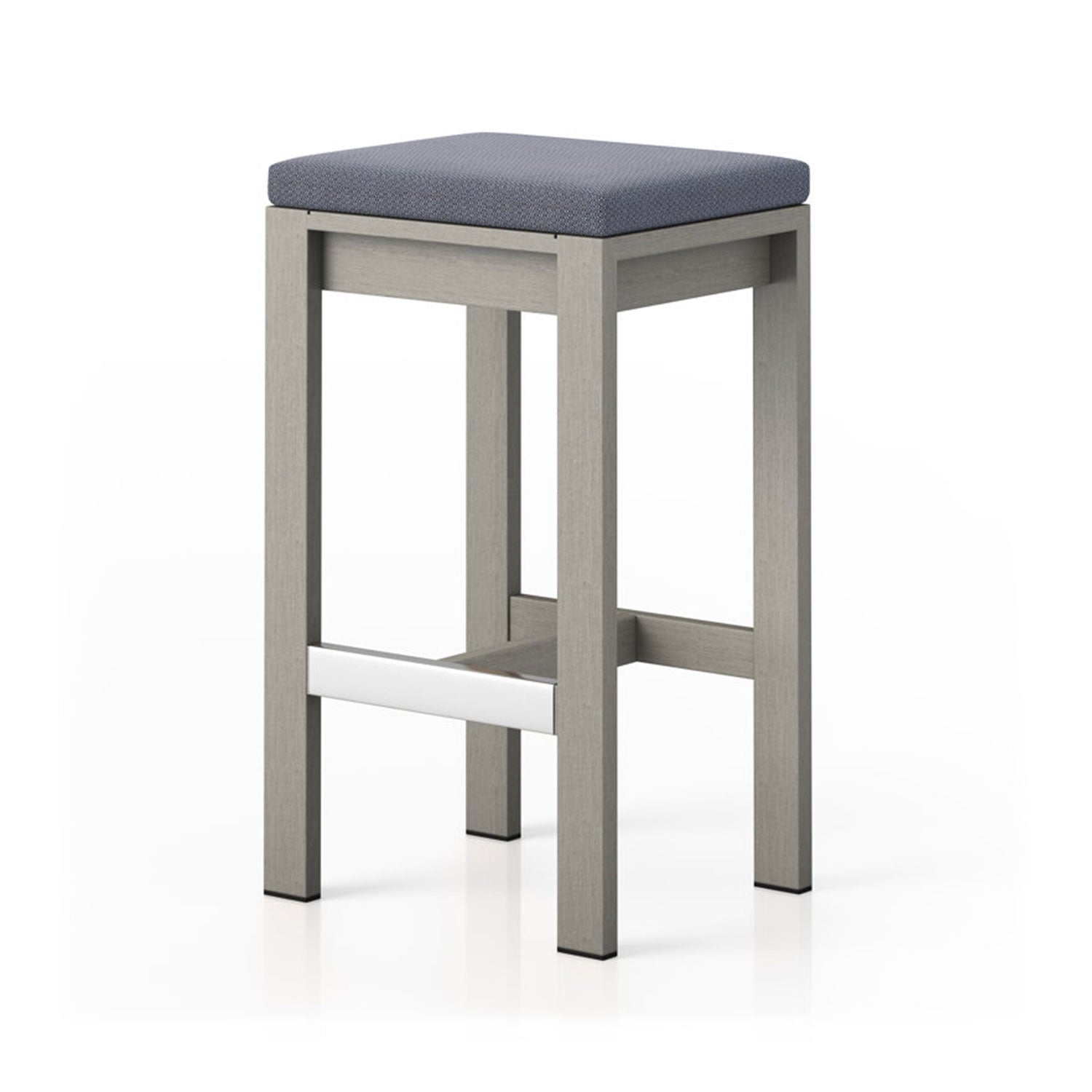 Backless outdoor bar stool with a light teak solid wood frame, square blue-gray upholstered seat cushion and a white front footrest accent in a minimalist contemporary coastal style on a white background.
