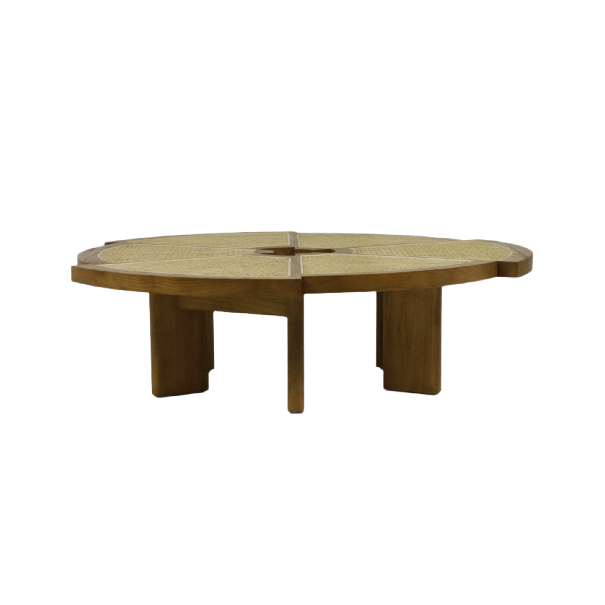 Low round solid wood coffee table with woven cane inset top divided into four panels and a central opening, natural wood finish and thick sculptural legs in a modern mid-century style.