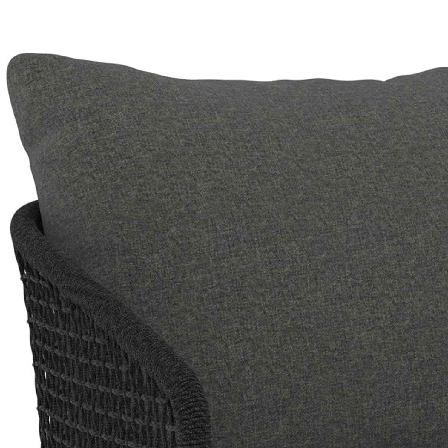 Close-up of a charcoal-gray upholstered fabric cushion and adjacent woven dark rope arm on a coastal outdoor bar stool.