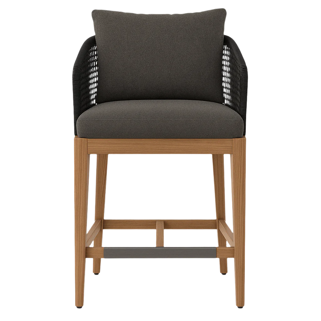 Front view of a coastal teak outdoor bar stool with natural teak wood frame, gray upholstered seat and back cushion, black woven rope arms, and a dark gray footrest plate.