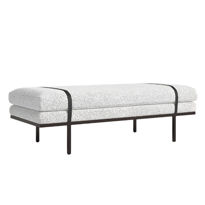 Low-profile coastal-modern end-of-bed bench upholstered in white boucle fabric with two dark wood straps and a slim dark wood base with four slender legs.