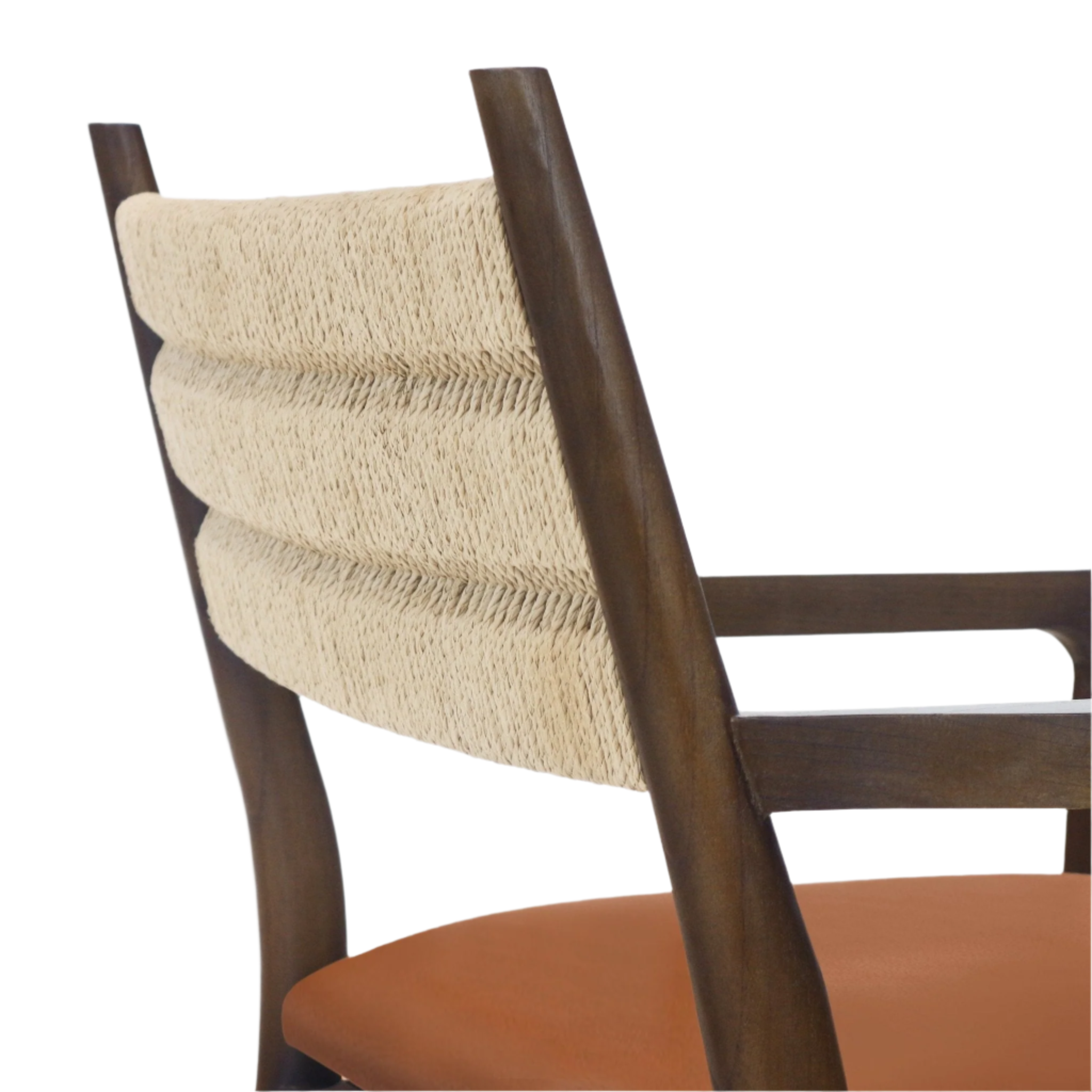 Close-up of a dining chair showing a natural woven rope backrest framed by dark-stained wood, a wooden armrest and a tan leather seat, highlighting coastal Scandinavian textures.