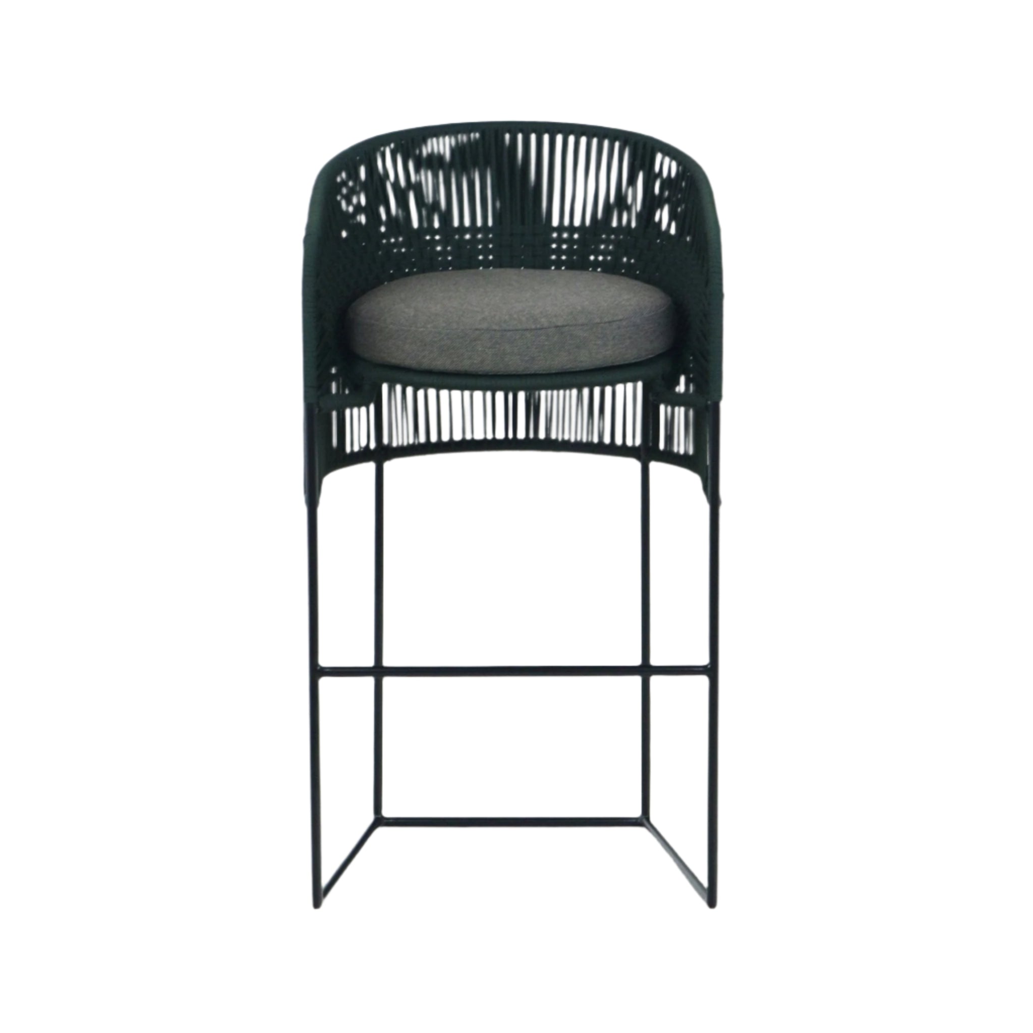 Outdoor bar stool with dark woven rope back and sides, a round gray fabric cushion, and a slim black metal frame with square base and integrated footrest for coastal-style counter seating.