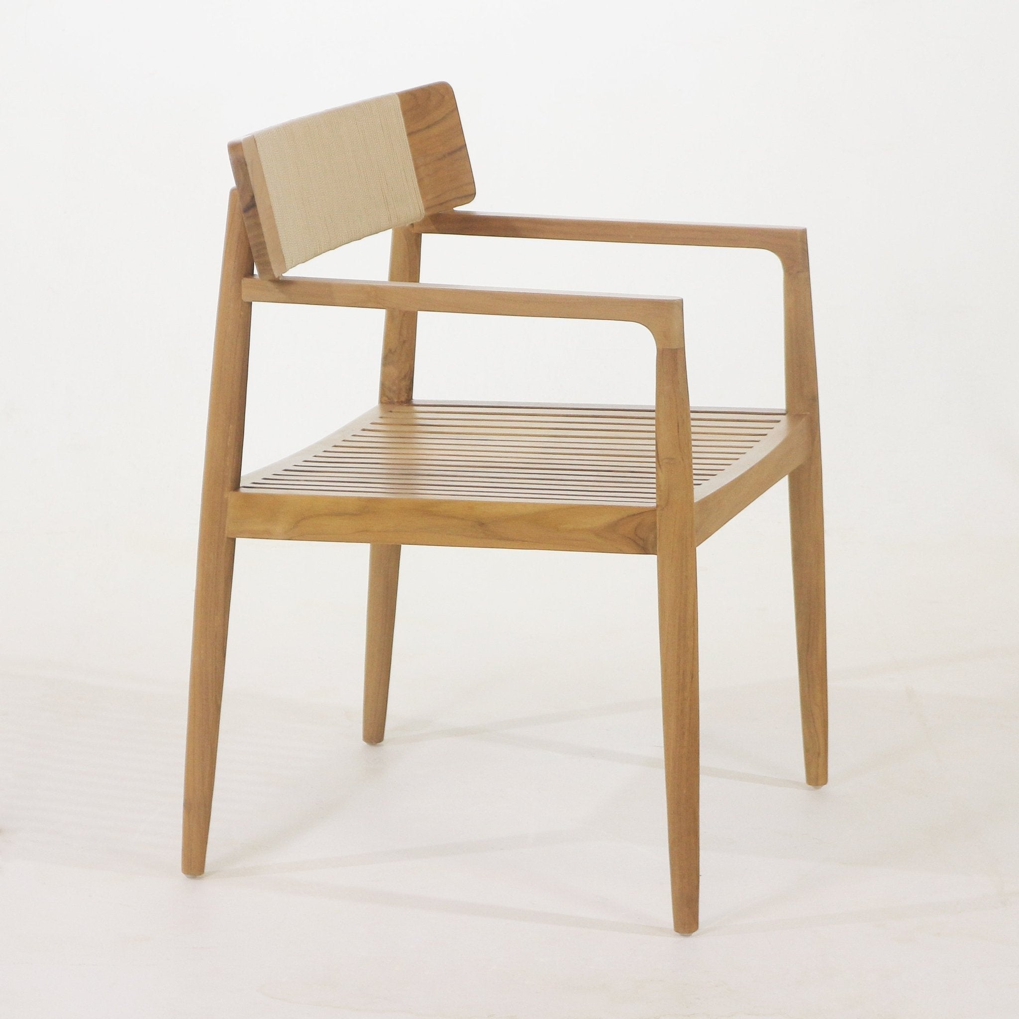 Natural teak dining chair with slatted wooden seat, slim tapered legs and open armrests; low rectangular back wrapped in a beige woven strap.