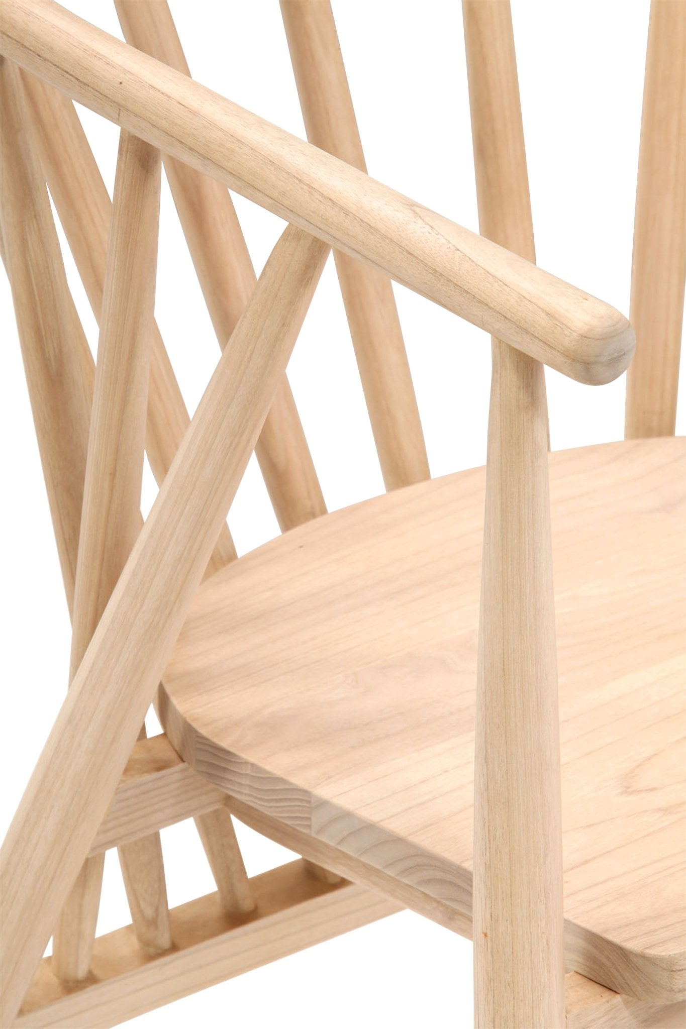 Close-up of a natural teak dining chair showing the rounded armrest, angled spindles and contoured wooden seat in a light natural finish.