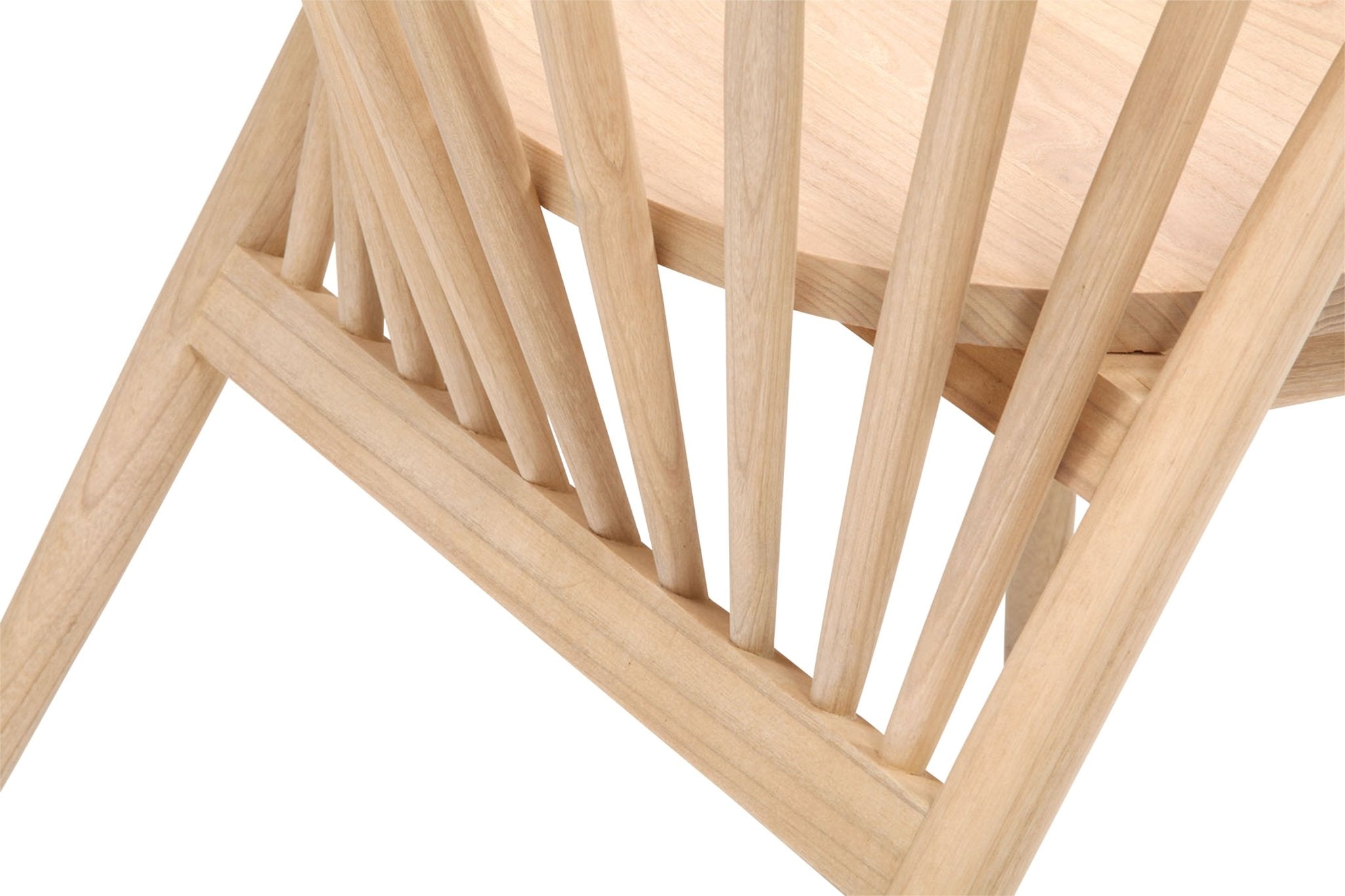 Close-up of a natural teak dining chair showing a solid wood seat, angled leg and vertical spindle back with visible wood grain in a mid-century modern style.