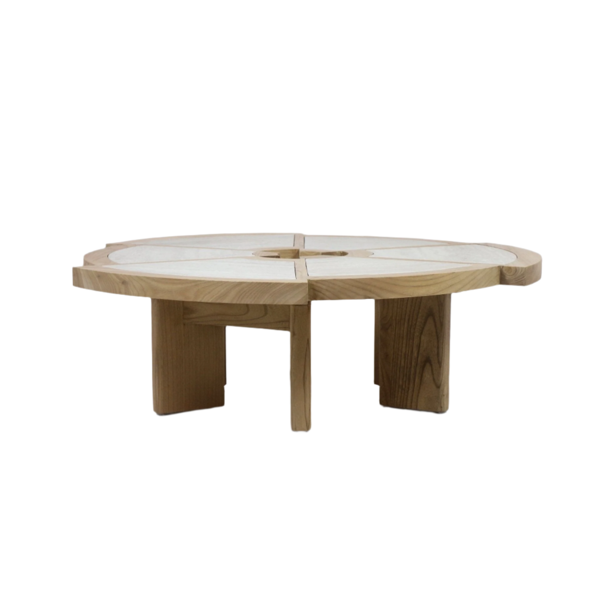 Large round coffee table in solid oak with natural light travertine inlaid into four segmented panels and a small central cutout, supported by low, thick oak pedestal legs in a modern contemporary style.