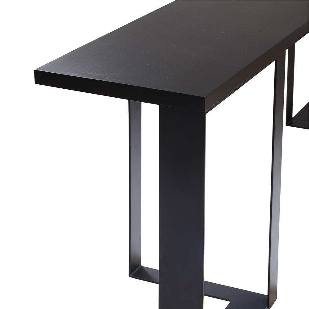 Close-up of a modern mahogany-black console showing the flat wood tabletop edge and rectangular steel beam leg with a matte black finish.