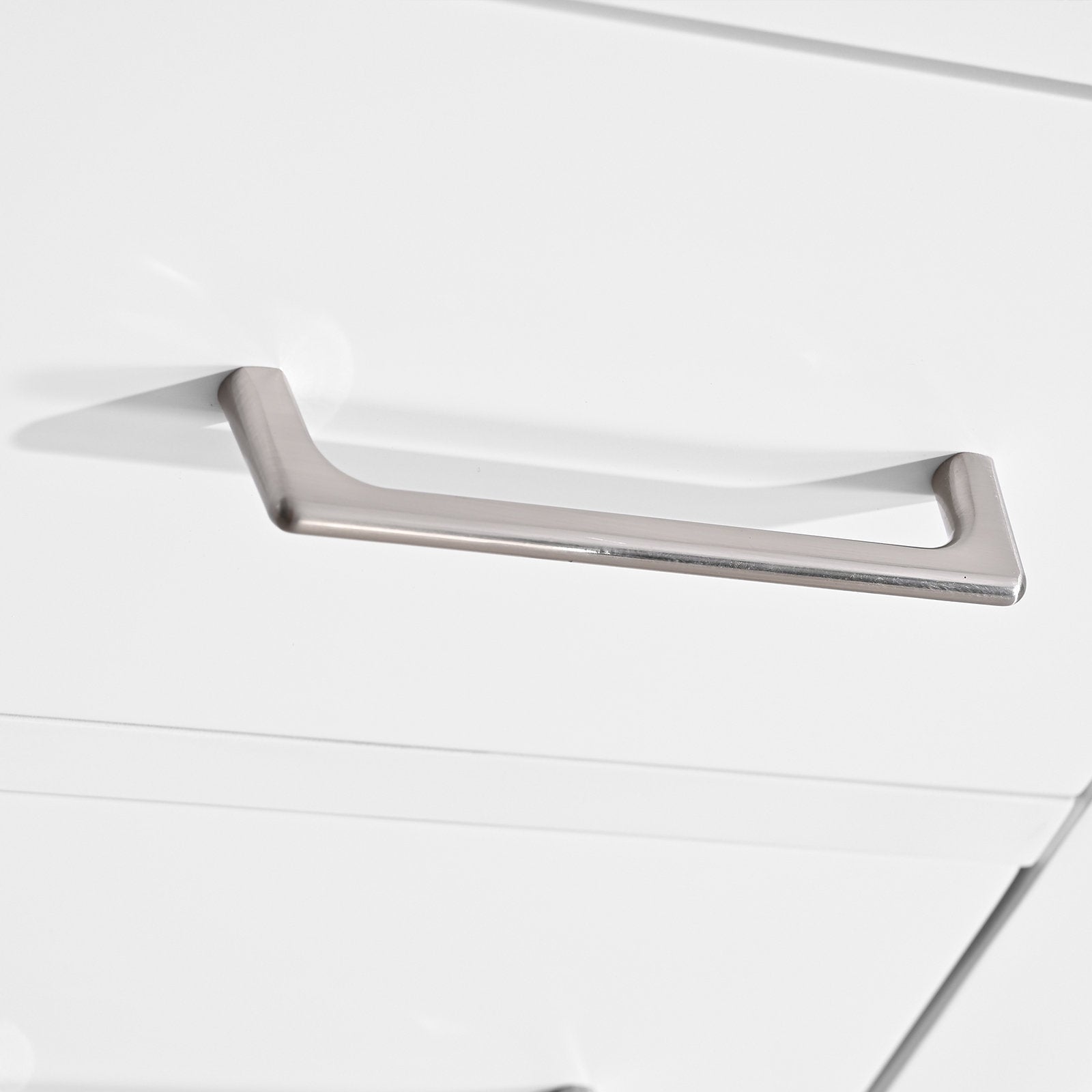 Close-up of a brushed metal rectangular drawer pull on a white solid-wood modern vanity drawer front, highlighting the handle’s smooth finish and recessed edge detail.