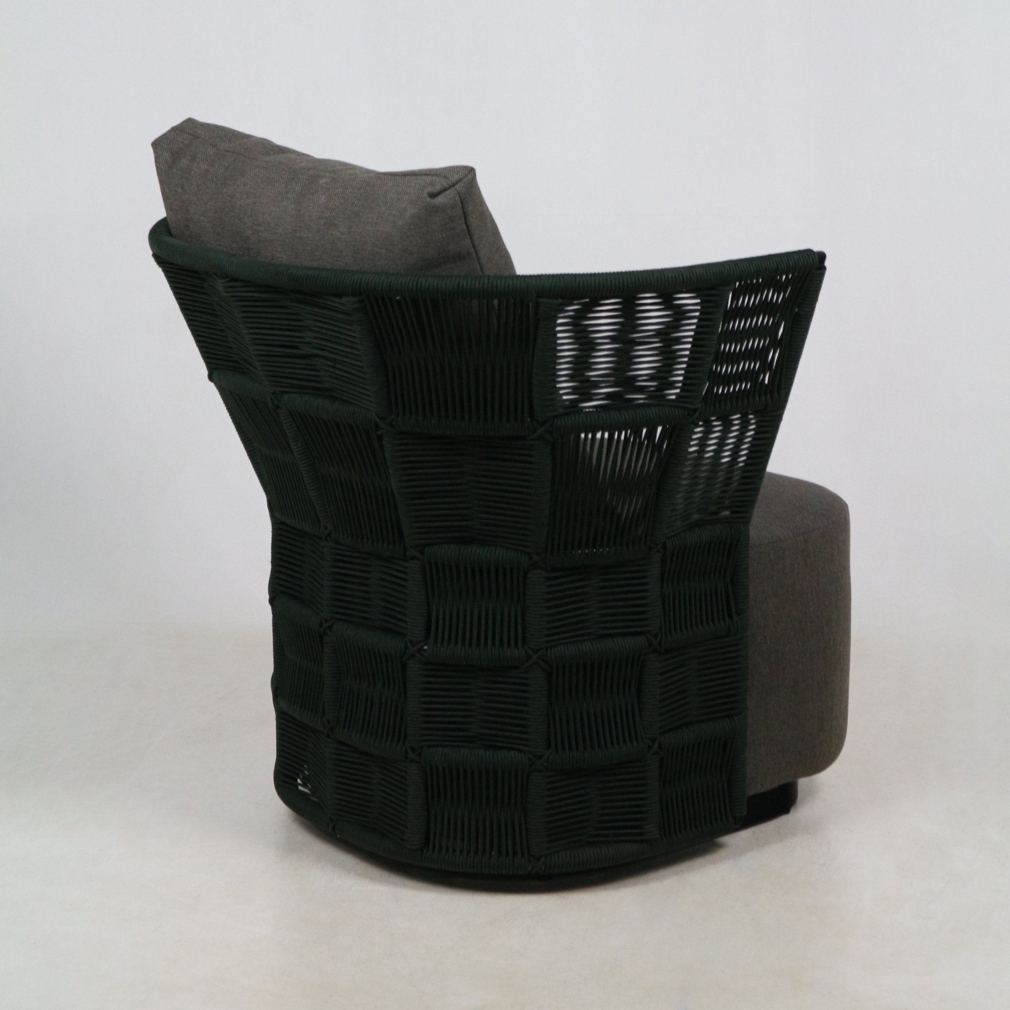 Rear three-quarter view of a coastal-modern outdoor accent chair with a dark woven rope back in a square checker pattern and a gray fabric upholstered seat and cushion on a neutral studio background.