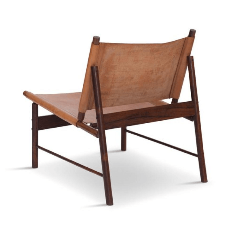 Armless mid-century modern lounge chair with a dark teak wood frame and tan stretch leather sling seat and back, shown from the rear on a white background.