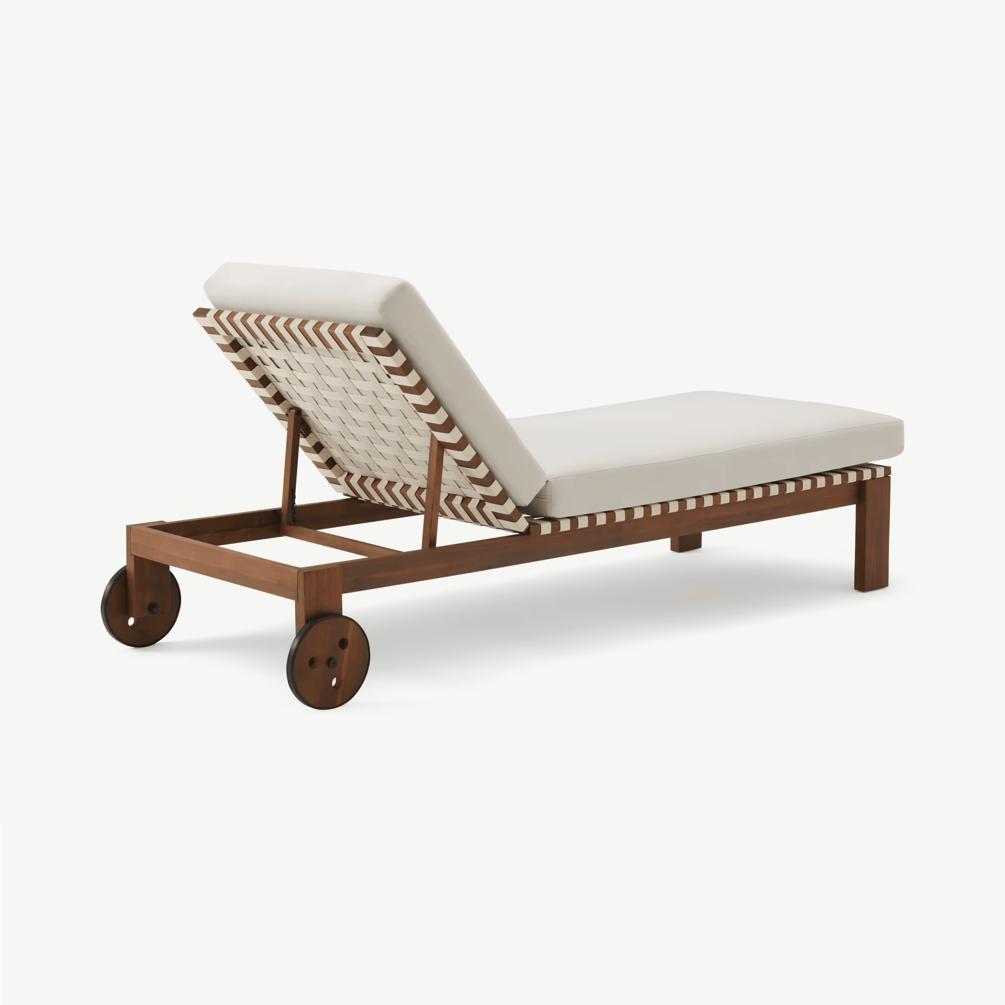 Teak-framed coastal outdoor sun lounger with a cream fabric cushion, woven cream-and-teak rope back detail, adjustable angled backrest and two teak wheels at the foot for easy repositioning.