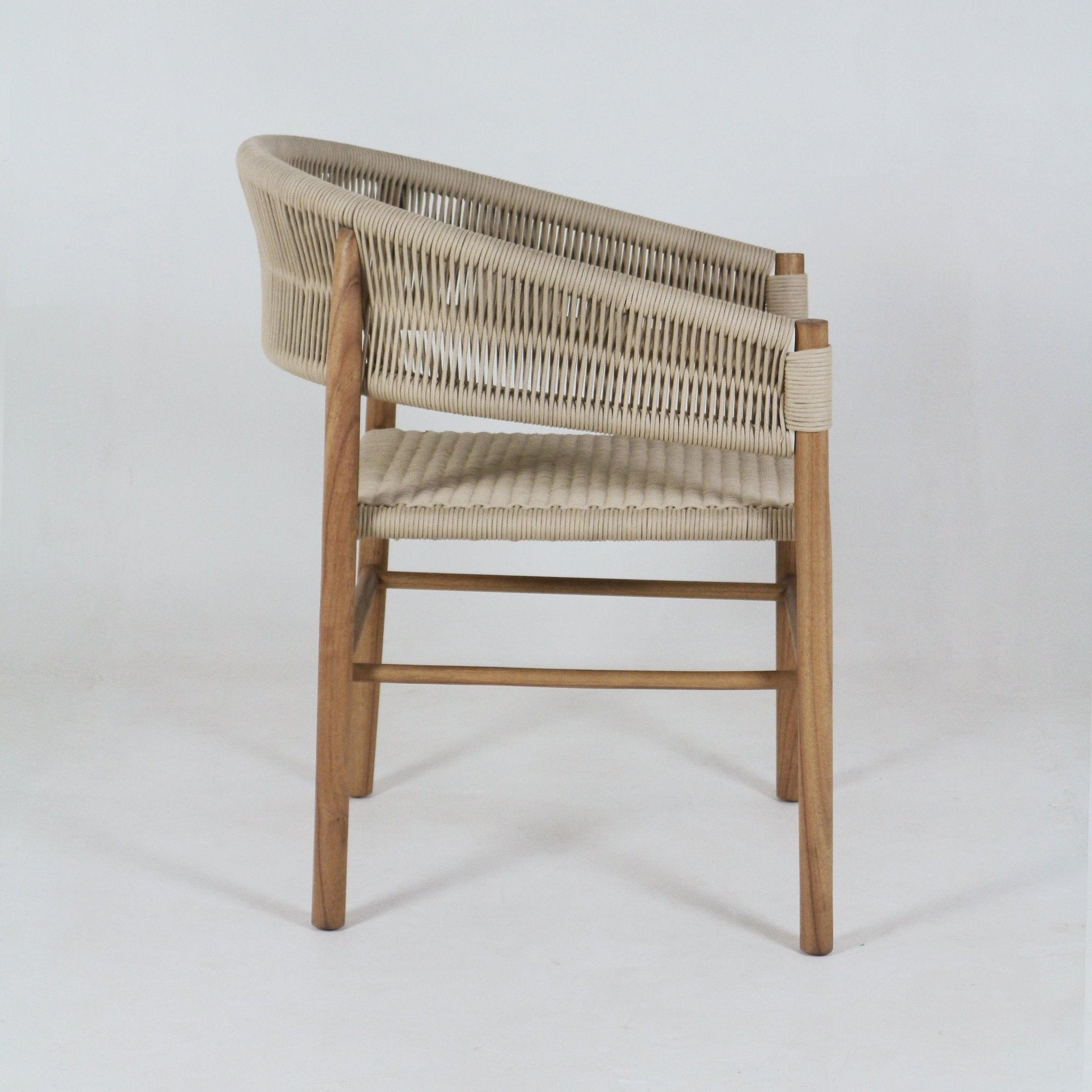 Side view of a coastal modern dining chair with a teak solid-wood frame and beige polypropylene rope-woven seat and wrapped backrest, shown on a plain white studio background.
